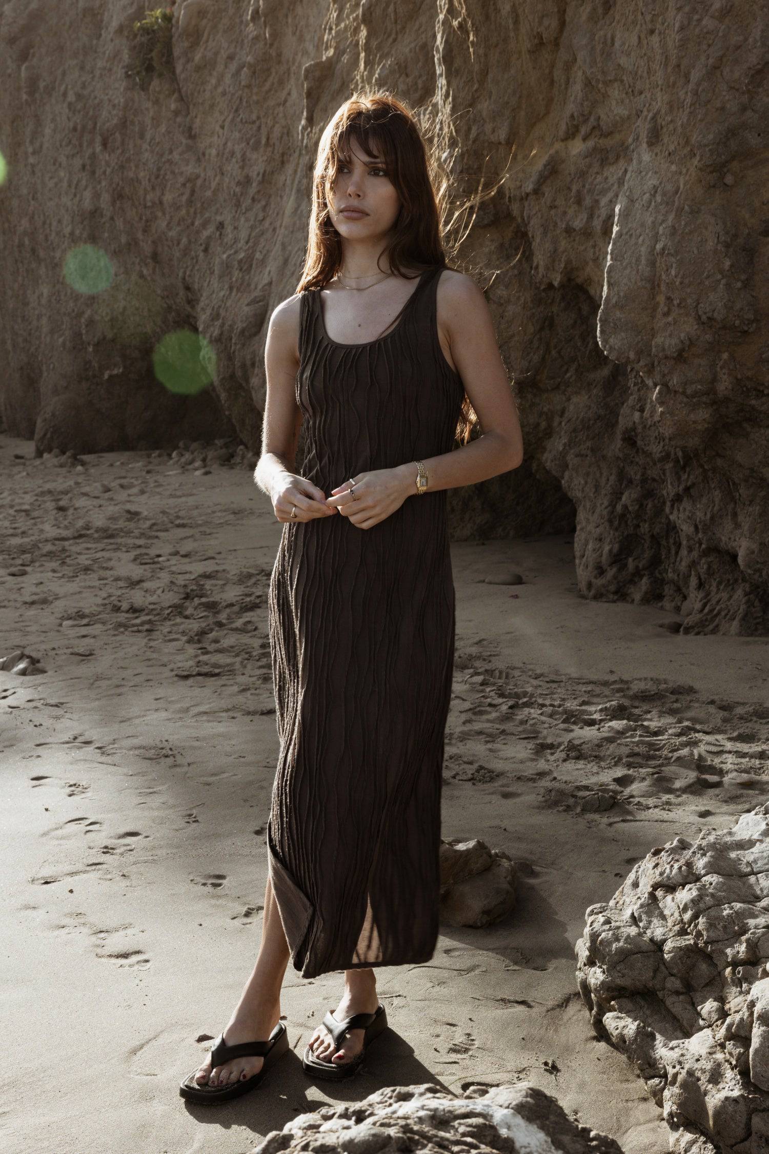 8861267755229, The Aliya Dress, Dress, All Row, Black,bodycon,brown,Casual,cf-color-black,cf-color-ivory,cf-size-l,cf-size-m,cf-size-s,cinched,ivory,Midi,new,nylon,racerback,rust,Sleeveless,Sleeveless Dress,Slit,spring,straight-cut,summer,texture,textured,Textured Fabric,viscose,Women's, Information The Aliya Dress is a tank midi dress that is crafted from a textured, pintucked stretch fabric. It boasts a sheer bodice and a scoop neckline. A summer addition piece to dress up or wear casually. Details Self: