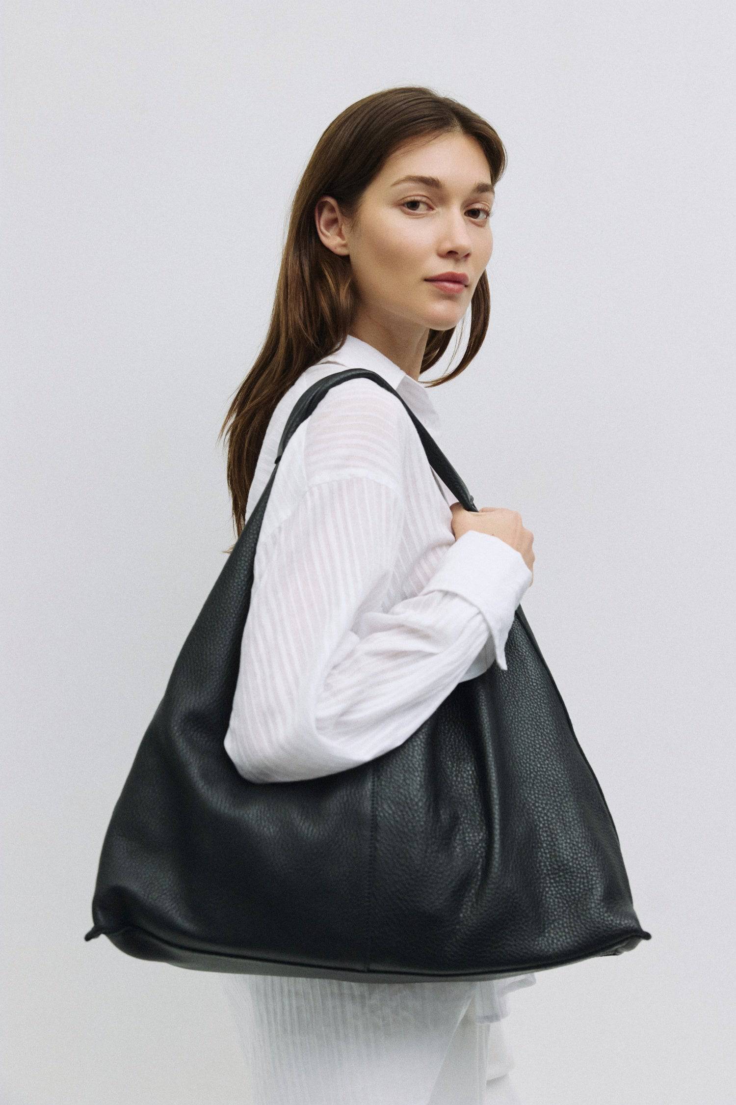 8857788776669, The Parker Bindle Bag, Bags, Mod Ref | Common Market, accessories,bag,bags,cf-color-khaki,cf-color-white,cf-vendor-mod-ref-common-market,dark brown,modrefcommonmarket,Oversized,purse, Information The Parker Bindle Bag is crafted from soft yet durable grain leather with a relaxed, slouchy shape and front seam detail. It features an integrated leather strap, suede lining, and a magnetic snap closure for effortless access and everyday use. Details 100% Cowhide Grain Leather Slouchy Shape Suede L