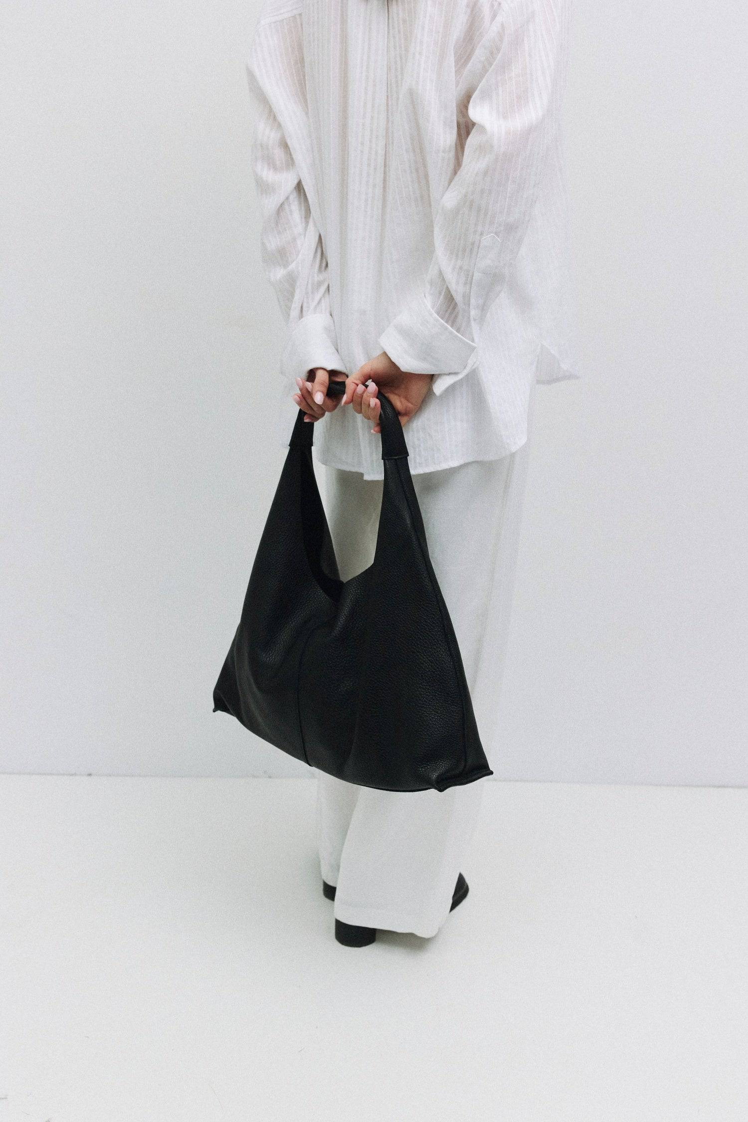 8857788776669, The Parker Bindle Bag, Bags, Mod Ref | Common Market, accessories,bag,bags,cf-color-khaki,cf-color-white,cf-vendor-mod-ref-common-market,dark brown,modrefcommonmarket,Oversized,purse, Information The Parker Bindle Bag is crafted from soft yet durable grain leather with a relaxed, slouchy shape and front seam detail. It features an integrated leather strap, suede lining, and a magnetic snap closure for effortless access and everyday use. Details 100% Cowhide Grain Leather Slouchy Shape Suede L