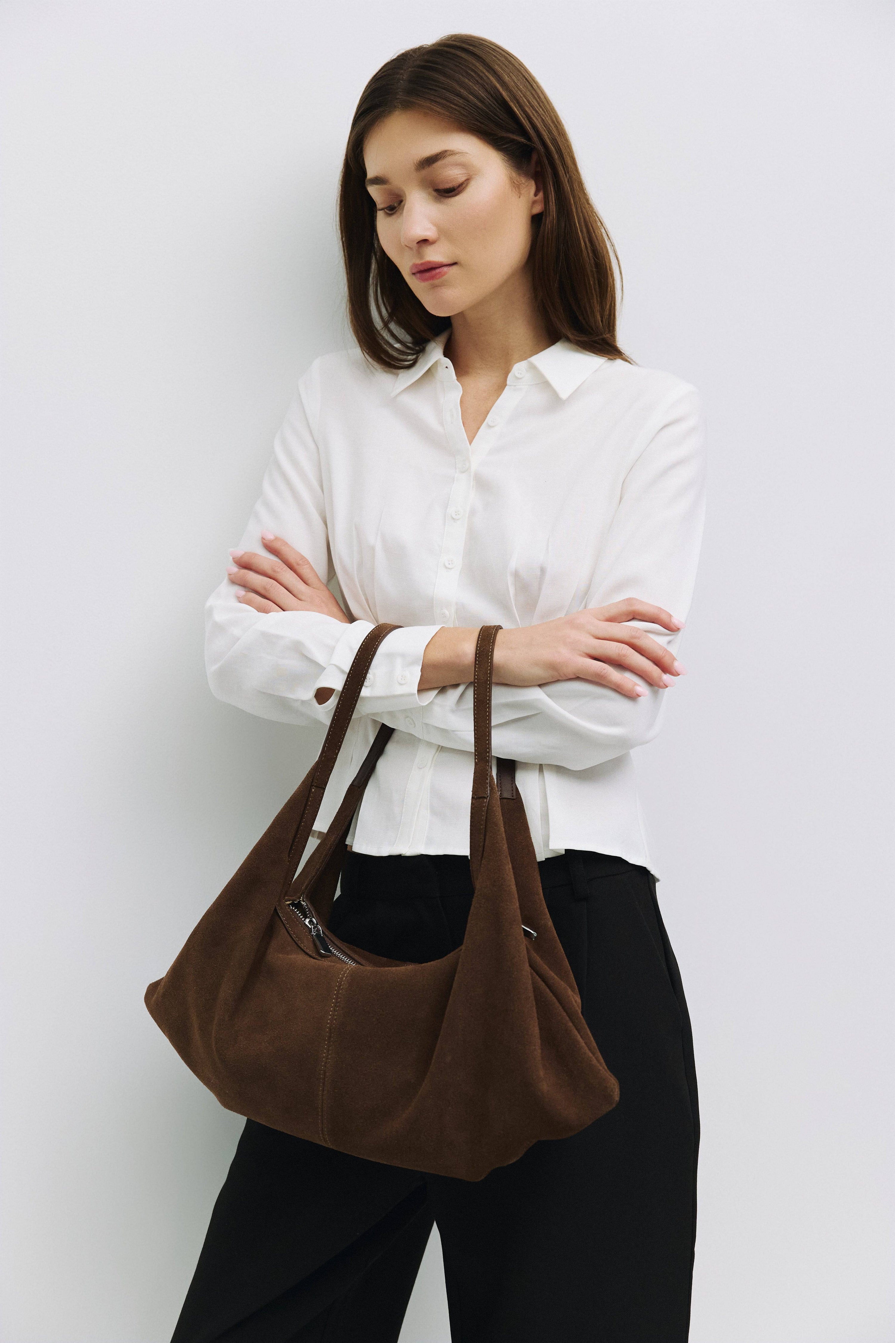 8857769345245, The Erin Shoulder Bag, Bags, Mod Ref | Common Market, accessories,bag,bags,cf-color-khaki,cf-color-white,cf-vendor-mod-ref-common-market,dark brown,modrefcommonmarket,Oversized,purse, Information The Erin Shoulder Bag features a relaxed, slouchy shape with a center seam detail and is crafted from suede leather for a modern look. The zip closure, inner pocket console, and detachable top strap offer both practicality and versatility for everyday use. Details 100% Cowhide Slouchy Shape Suede Lea