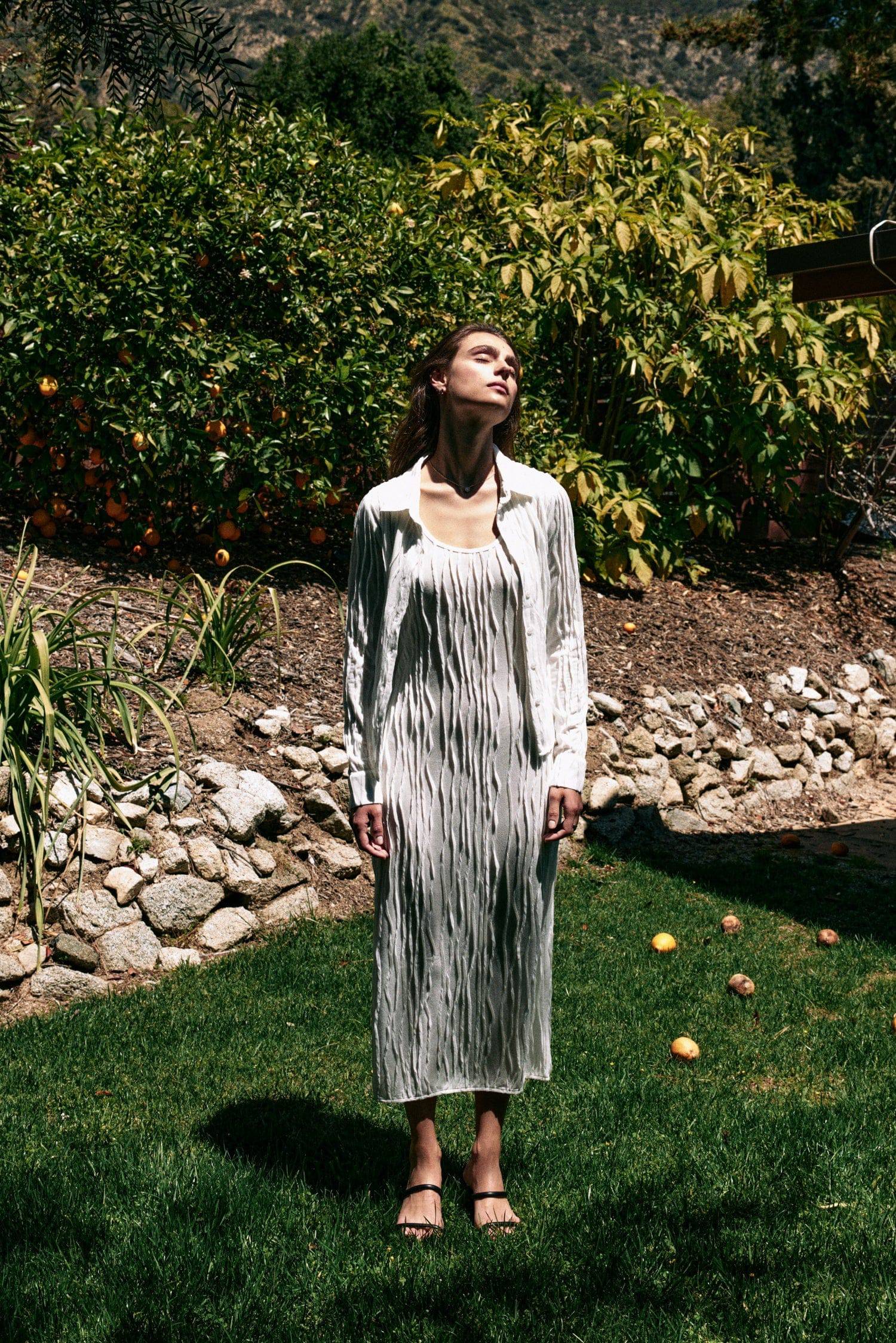 8861267755229, The Aliya Dress, Dress, All Row, Black,bodycon,brown,Casual,cf-color-black,cf-color-ivory,cf-size-l,cf-size-m,cf-size-s,cinched,ivory,Midi,new,nylon,racerback,rust,Sleeveless,Sleeveless Dress,Slit,spring,straight-cut,summer,texture,textured,Textured Fabric,viscose,Women's, Information The Aliya Dress is a tank midi dress that is crafted from a textured, pintucked stretch fabric. It boasts a sheer bodice and a scoop neckline. A summer addition piece to dress up or wear casually. Details Self: