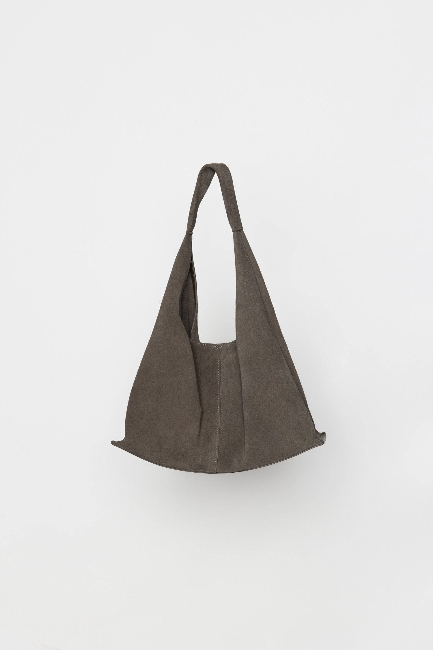8857791201501, The Kaila Bindle Bag, Bags, Mod Ref | Common Market, accessories,bag,bags,cf-color-khaki,cf-color-white,cf-vendor-mod-ref-common-market,dark brown,modrefcommonmarket,Oversized,purse, Information The Kaila Bindle Bag features a slouchy shape with a front seam detail offering a touch of effortless style. Crafted with an integrated suede strap, durable patent leather bottom support, and a magnetic snap closure, it combines practicality with a laid-back, contemporary feel. Details 100% Cowhide Fr