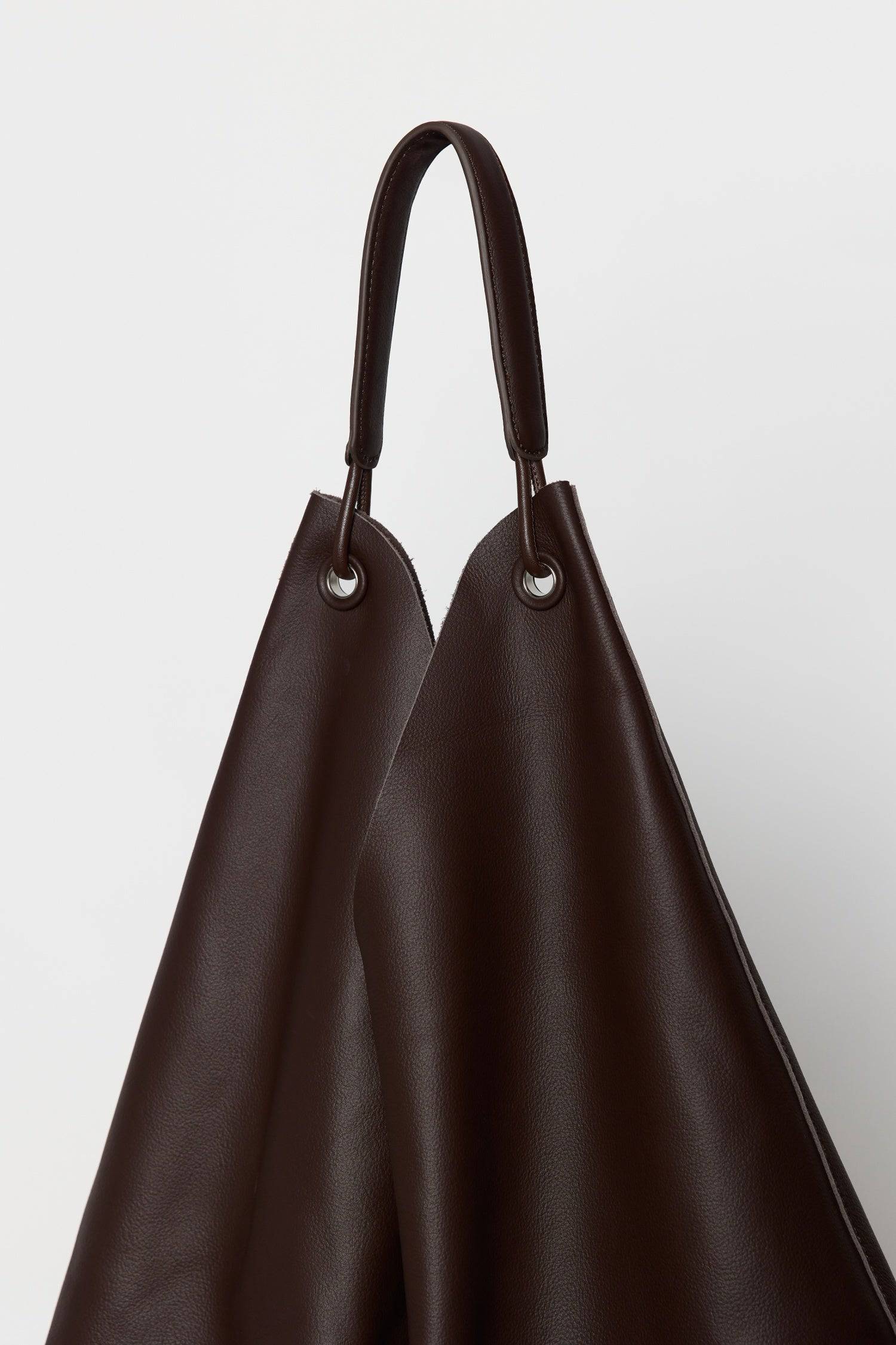 8857790644445, The Kenzie Bindle Bag, Bags, Mod Ref | Common Market, accessories,bag,bags,cf-color-khaki,cf-color-white,cf-vendor-mod-ref-common-market,dark brown,modrefcommonmarket,Oversized,purse, Information The Kenzie Bindle Bag is a spacious, oversized shoulder bag crafted from 100% cowhide combining lasting durability with a refined, natural texture. Designed for both style and practicality, it features an open top for easy access, a secure interior zipper pocket, and a soft suede lining for a touch o