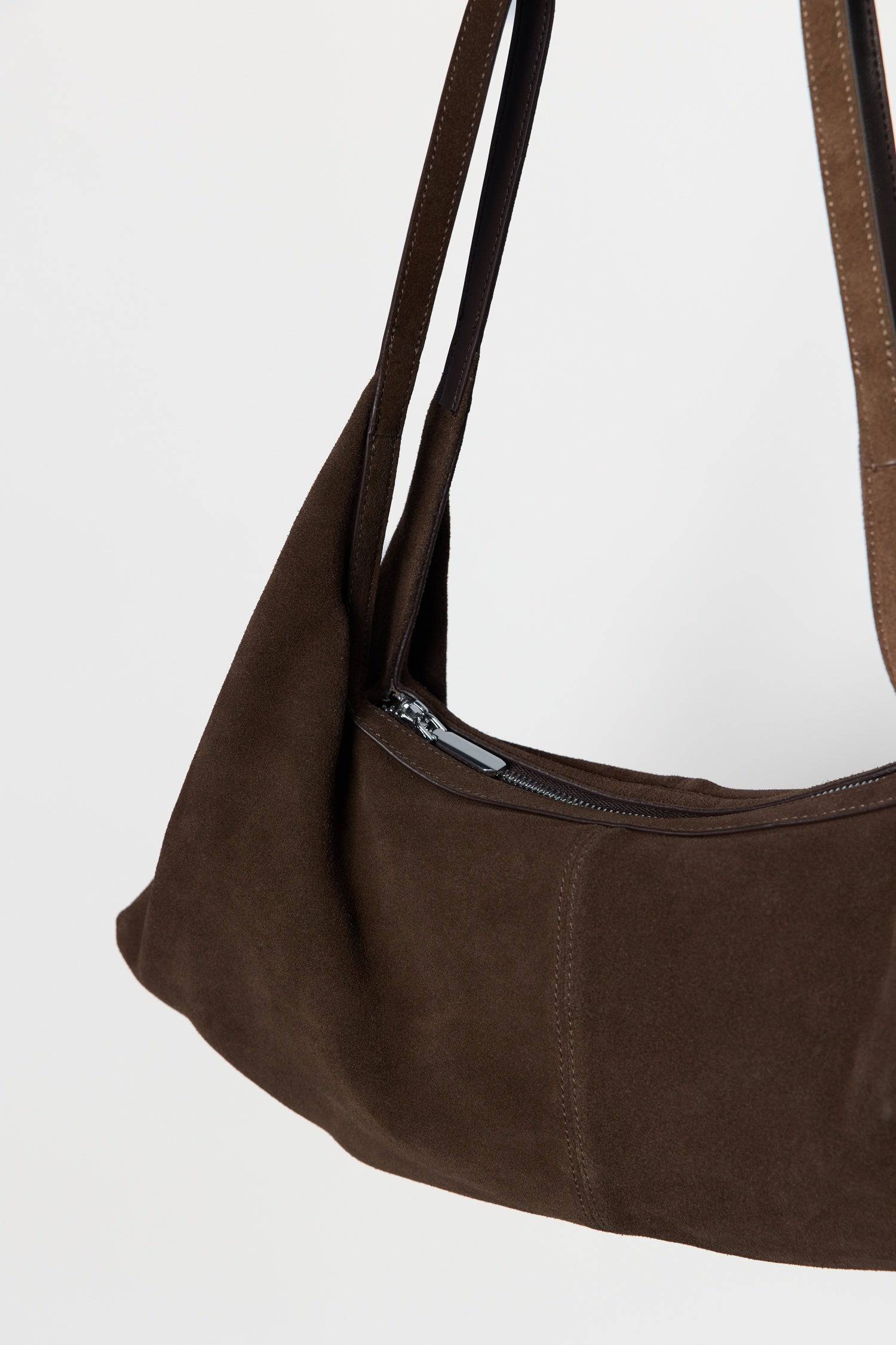8857769345245, The Erin Shoulder Bag, Bags, Mod Ref | Common Market, accessories,bag,bags,cf-color-khaki,cf-color-white,cf-vendor-mod-ref-common-market,dark brown,modrefcommonmarket,Oversized,purse, Information The Erin Shoulder Bag features a relaxed, slouchy shape with a center seam detail and is crafted from suede leather for a modern look. The zip closure, inner pocket console, and detachable top strap offer both practicality and versatility for everyday use. Details 100% Cowhide Slouchy Shape Suede Lea