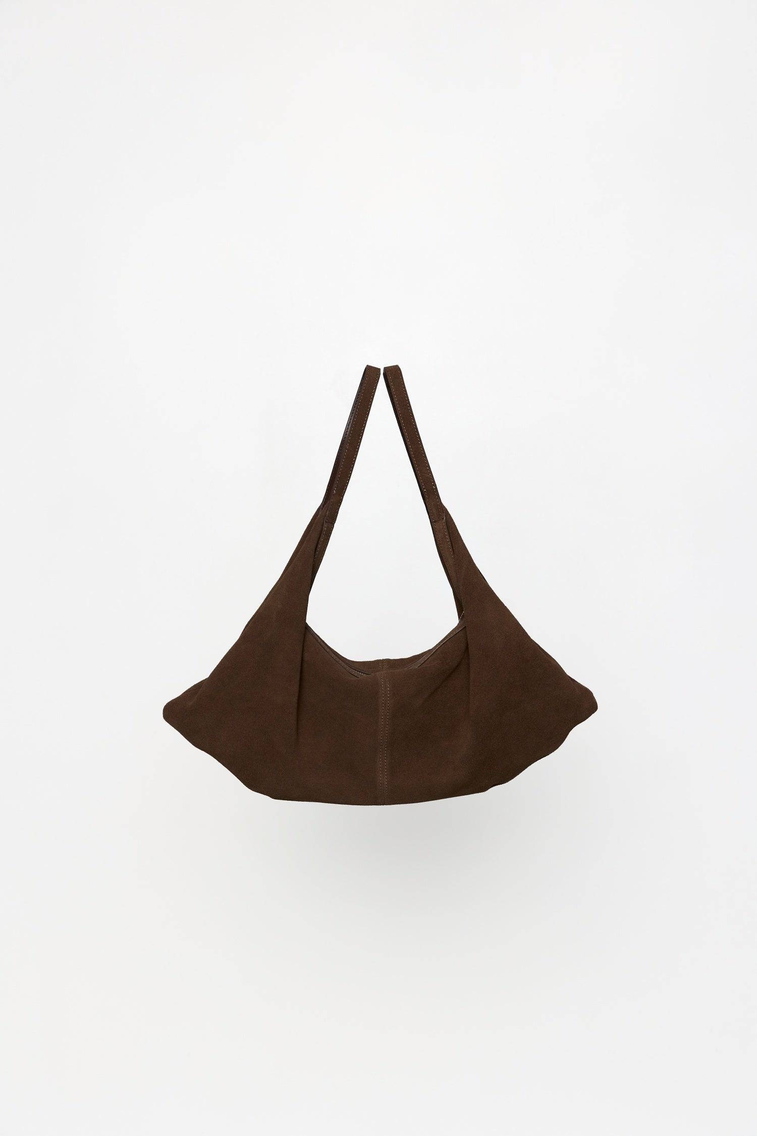 8857769345245, The Erin Shoulder Bag, Bags, Mod Ref | Common Market, accessories,bag,bags,cf-color-khaki,cf-color-white,cf-vendor-mod-ref-common-market,dark brown,modrefcommonmarket,Oversized,purse, Information The Erin Shoulder Bag features a relaxed, slouchy shape with a center seam detail and is crafted from suede leather for a modern look. The zip closure, inner pocket console, and detachable top strap offer both practicality and versatility for everyday use. Details 100% Cowhide Slouchy Shape Suede Lea