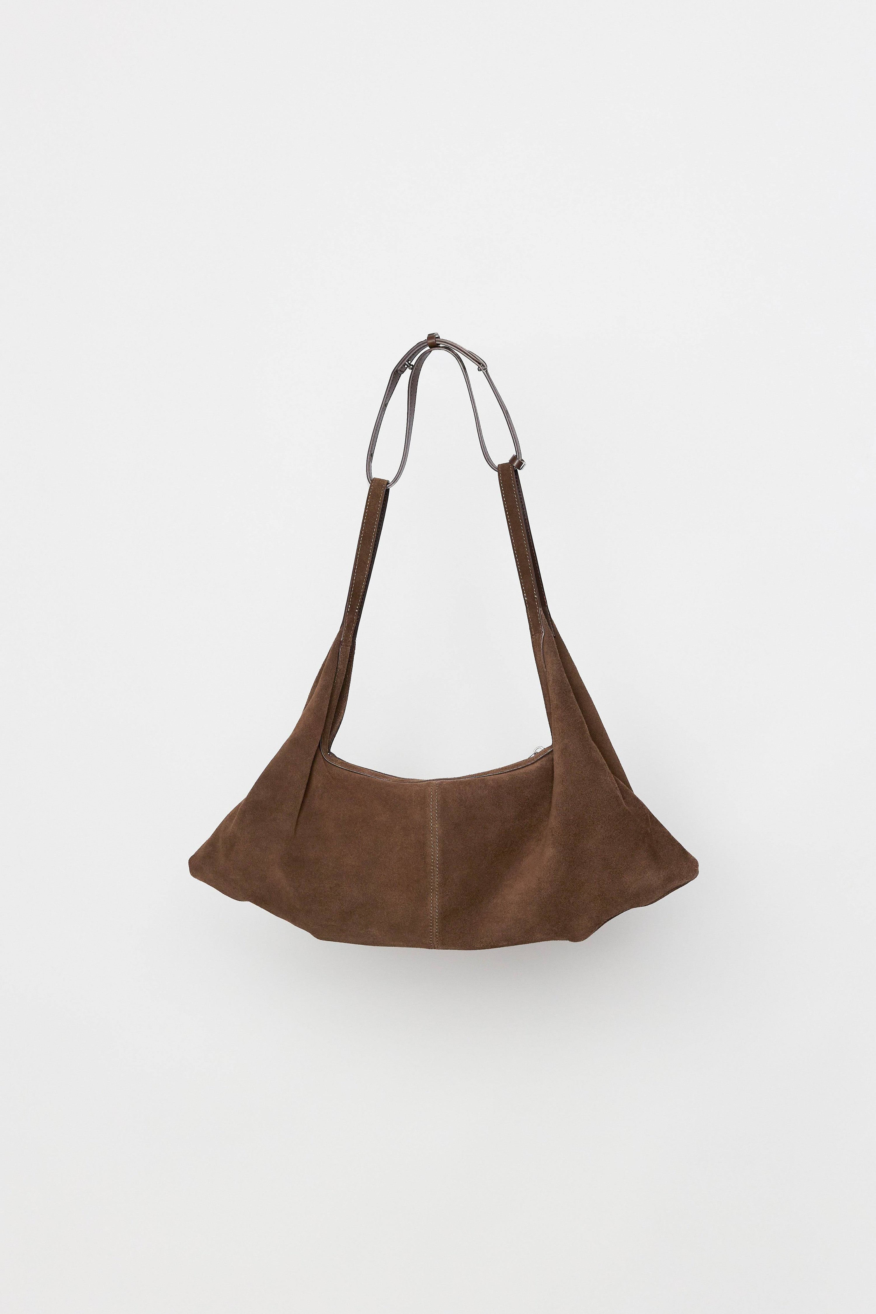 8857769345245, The Erin Shoulder Bag, Bags, Mod Ref | Common Market, accessories,bag,bags,cf-color-khaki,cf-color-white,cf-vendor-mod-ref-common-market,dark brown,modrefcommonmarket,Oversized,purse, Information The Erin Shoulder Bag features a relaxed, slouchy shape with a center seam detail and is crafted from suede leather for a modern look. The zip closure, inner pocket console, and detachable top strap offer both practicality and versatility for everyday use. Details 100% Cowhide Slouchy Shape Suede Lea