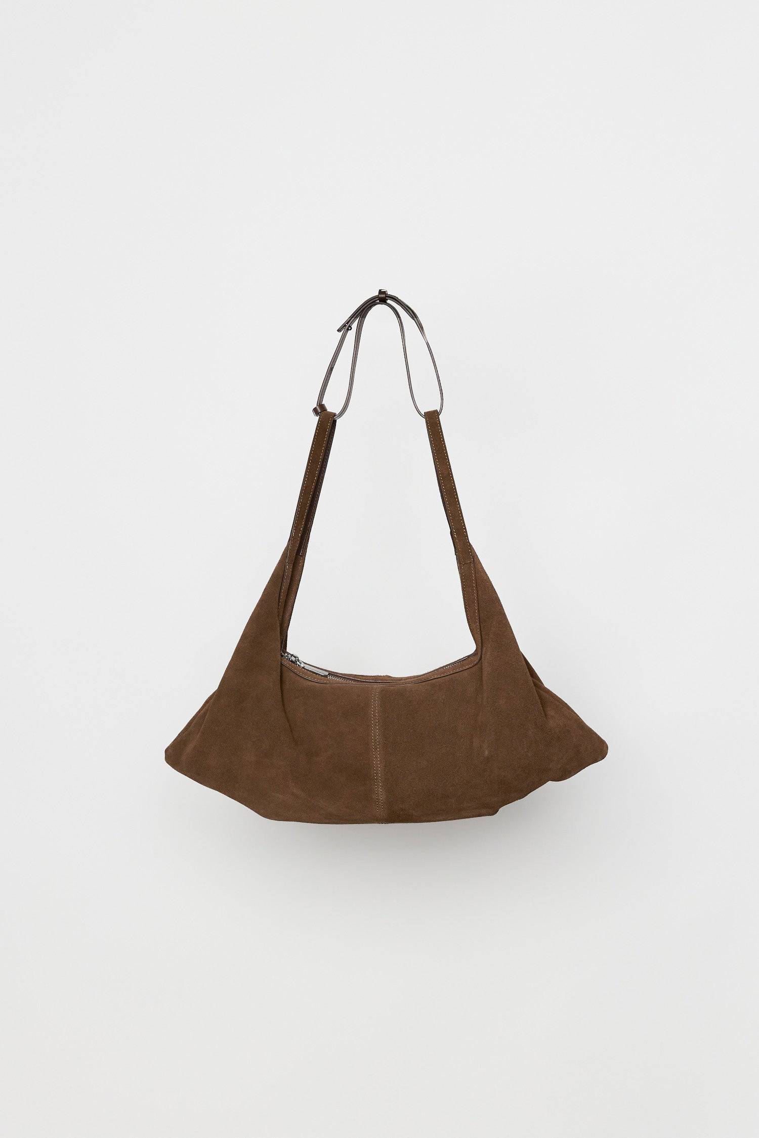 8857769345245, The Erin Shoulder Bag, Bags, Mod Ref | Common Market, accessories,bag,bags,cf-color-khaki,cf-color-white,cf-vendor-mod-ref-common-market,dark brown,modrefcommonmarket,Oversized,purse, Information The Erin Shoulder Bag features a relaxed, slouchy shape with a center seam detail and is crafted from suede leather for a modern look. The zip closure, inner pocket console, and detachable top strap offer both practicality and versatility for everyday use. Details 100% Cowhide Slouchy Shape Suede Lea