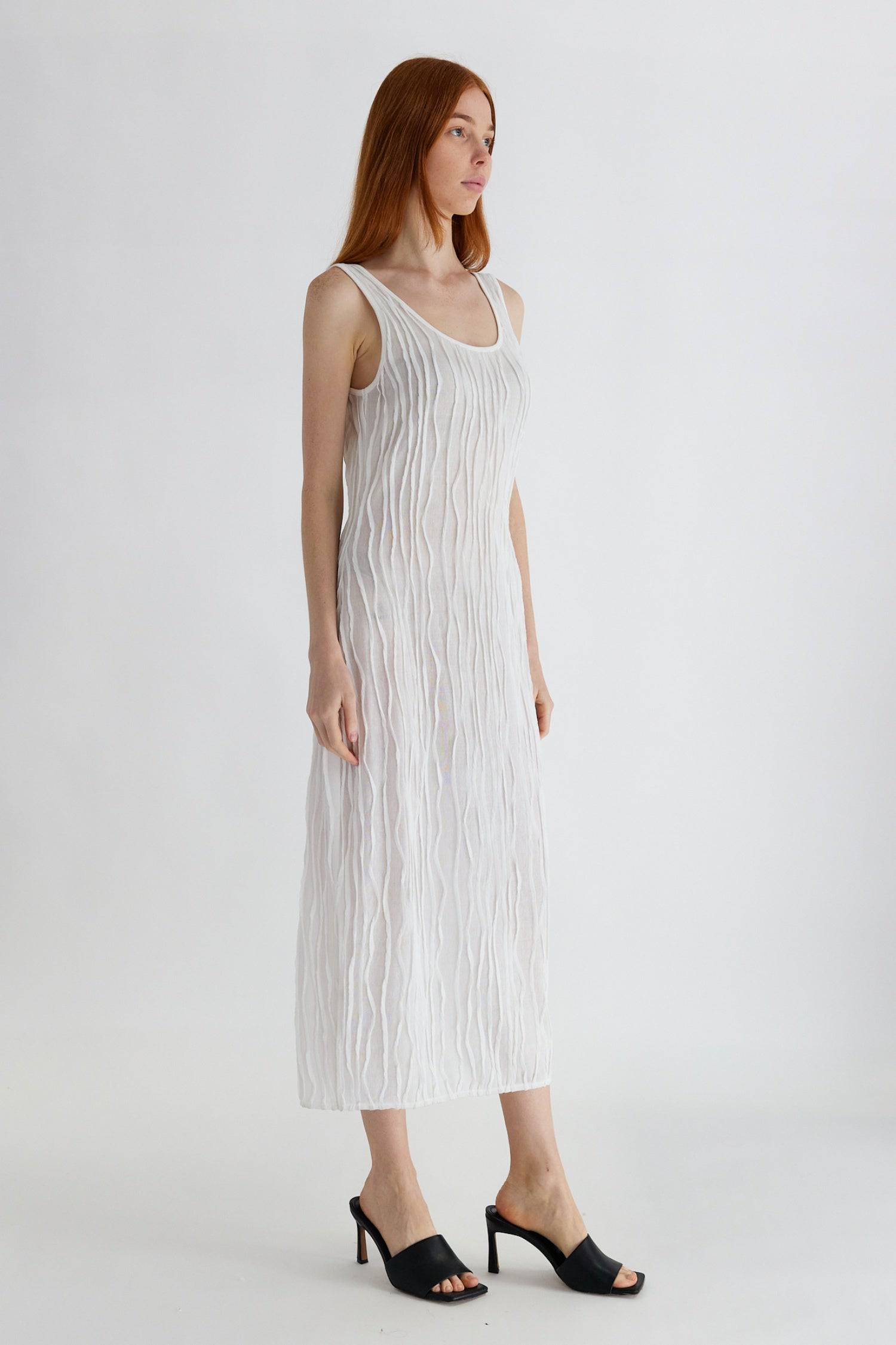 8861267755229, The Aliya Dress, Dress, All Row, Black,bodycon,brown,Casual,cf-color-black,cf-color-ivory,cf-size-l,cf-size-m,cf-size-s,cinched,ivory,Midi,new,nylon,racerback,rust,Sleeveless,Sleeveless Dress,Slit,spring,straight-cut,summer,texture,textured,Textured Fabric,viscose,Women's, Information The Aliya Dress is a tank midi dress that is crafted from a textured, pintucked stretch fabric. It boasts a sheer bodice and a scoop neckline. A summer addition piece to dress up or wear casually. Details Self: