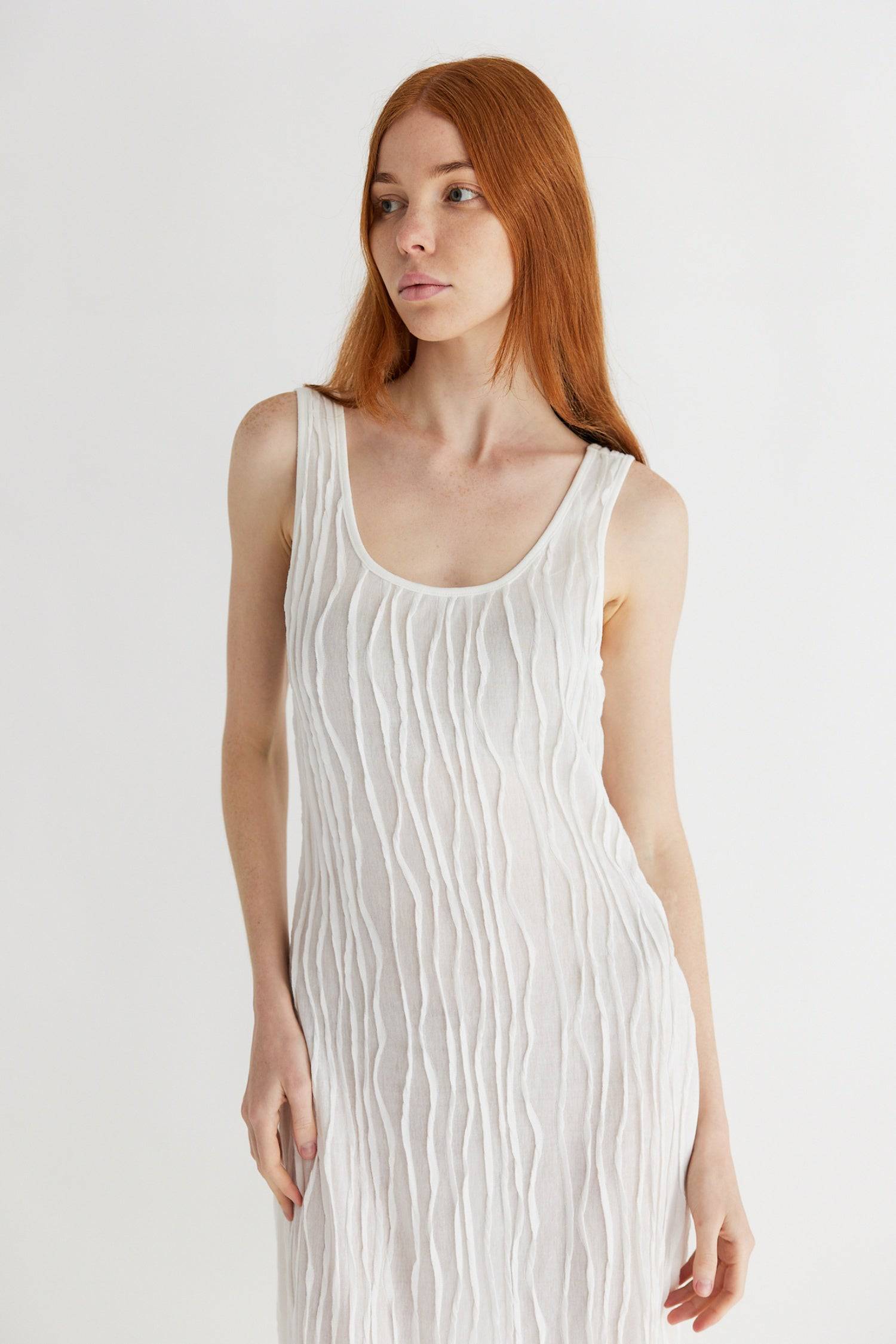 8861267755229, The Aliya Dress, Dress, All Row, Black,bodycon,brown,Casual,cf-color-black,cf-color-ivory,cf-size-l,cf-size-m,cf-size-s,cinched,ivory,Midi,new,nylon,racerback,rust,Sleeveless,Sleeveless Dress,Slit,spring,straight-cut,summer,texture,textured,Textured Fabric,viscose,Women's, Information The Aliya Dress is a tank midi dress that is crafted from a textured, pintucked stretch fabric. It boasts a sheer bodice and a scoop neckline. A summer addition piece to dress up or wear casually. Details Self: