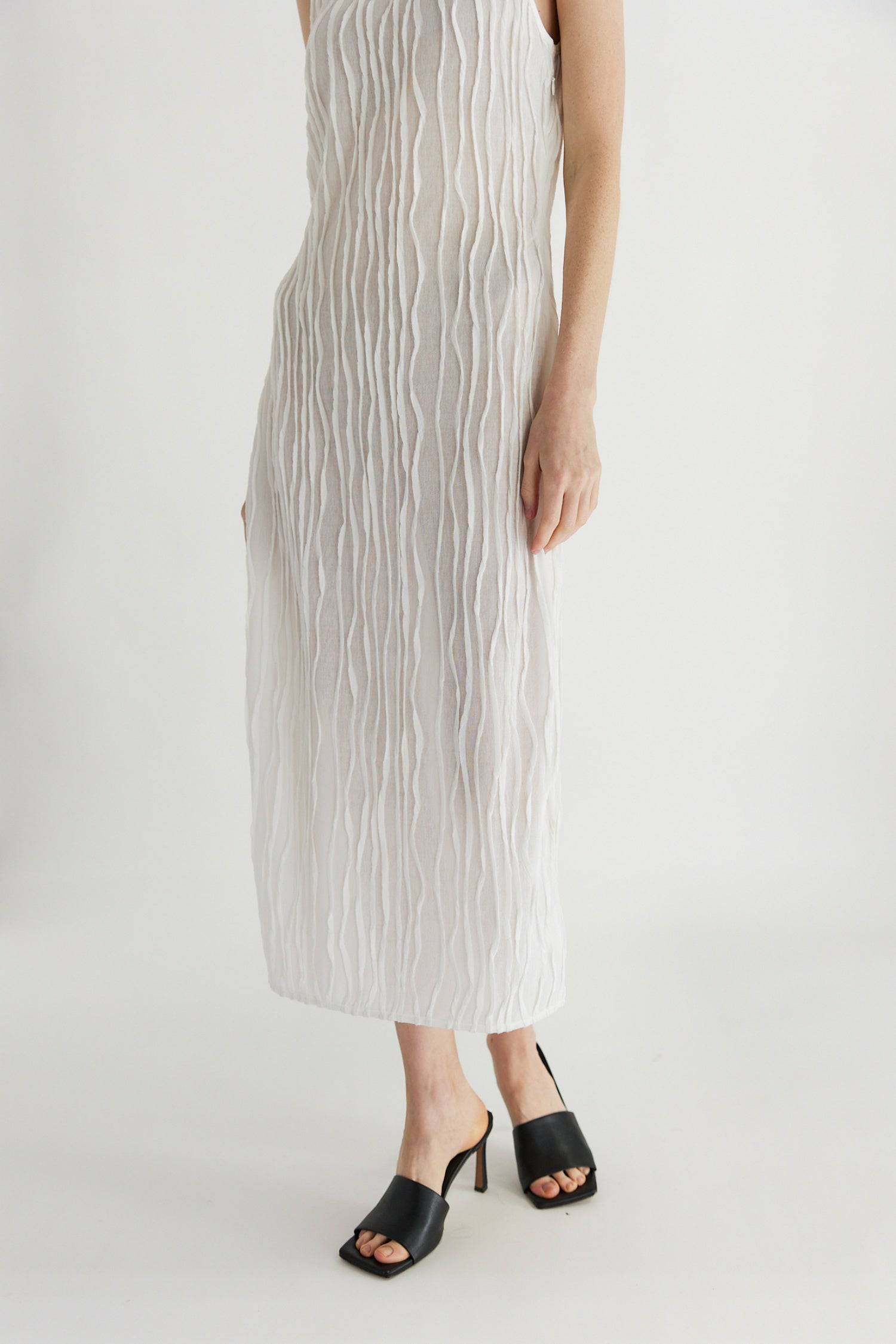 8861267755229, The Aliya Dress, Dress, All Row, Black,bodycon,brown,Casual,cf-color-black,cf-color-ivory,cf-size-l,cf-size-m,cf-size-s,cinched,ivory,Midi,new,nylon,racerback,rust,Sleeveless,Sleeveless Dress,Slit,spring,straight-cut,summer,texture,textured,Textured Fabric,viscose,Women's, Information The Aliya Dress is a tank midi dress that is crafted from a textured, pintucked stretch fabric. It boasts a sheer bodice and a scoop neckline. A summer addition piece to dress up or wear casually. Details Self: