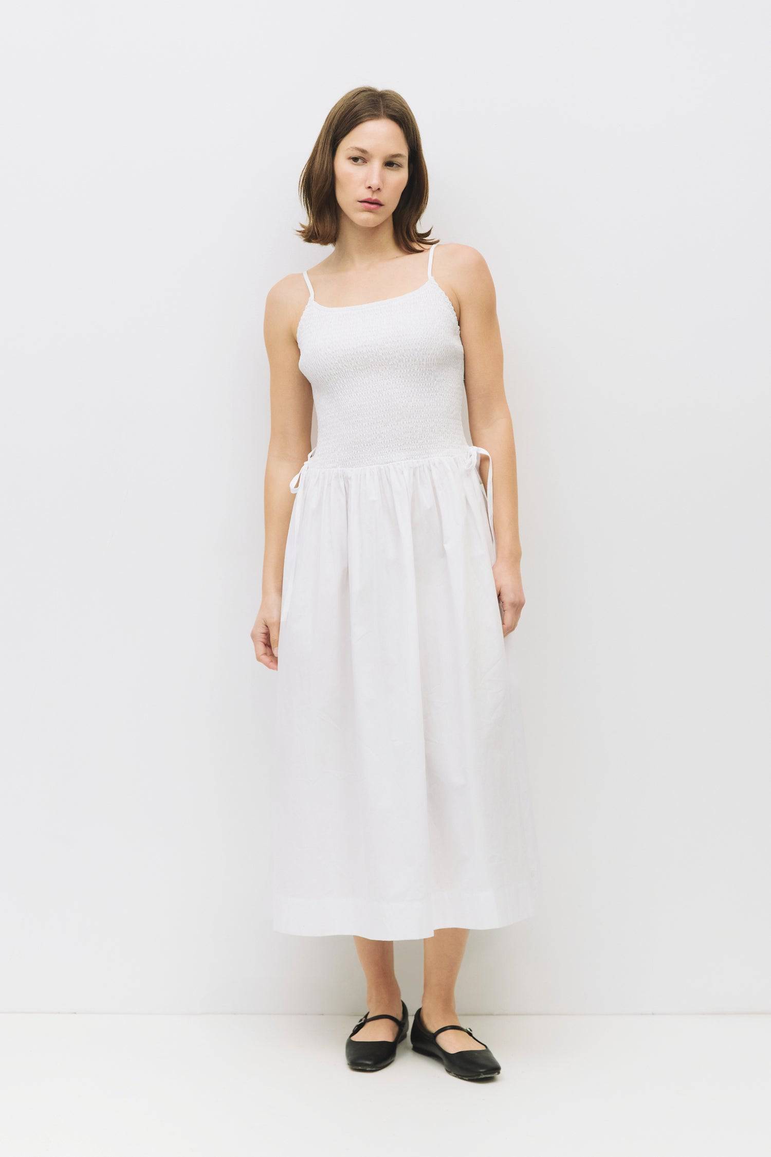 8954057949405, The Jenni Dress, Dress, All Row, adjustable straps,Casual,cf-color-black,cf-color-navy,cf-color-white,cf-color-yellow,cf-size-l,cf-vendor-all-row,Comfort,Comfortable,Elastic Waist,Feminine,full skirt,Midi,Midi Dress,midi length,Navy,new,Pockets,Semi-Formal,Sleeveless,Sleeveless Dress,Spring,versatile,white,Womens,Yellow, Information The Jenni Dress is your go to dress for the spring and summer. It features a smocked top with adjustable back tie straps, fastened side ties, and shirring detail