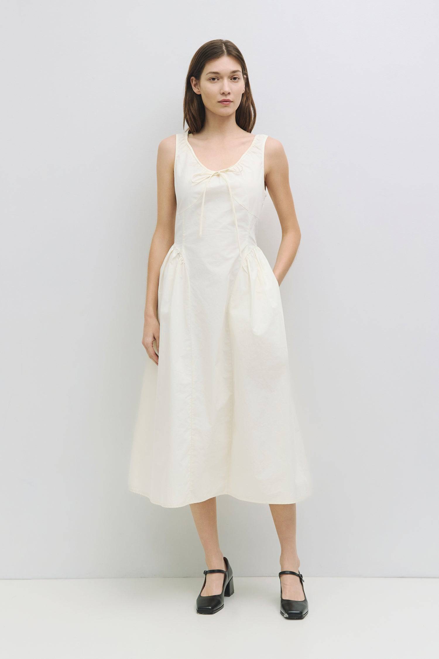 8911662874845, The Anika Dress, Dress, All Row, Casual,cf-color-white,cf-size-l,cf-size-m,cf-size-s,cf-vendor-mod-ref,Cinched Waist,Comfortable,Cotton,curve skirt,drawstring waist,Dress,dressy,final-sale,finalsale,Long Dress,maxi dress,Mid Length Dress,Midi,Midi Dress,midi length,new,sale,side pockets,Sleeveless,Spring,Summer,voluminous,womens, Information The Anika Dress is a comfortable sleeveless midi dress featuring a gathered neck design and front ties for a personalized fit. With shirring around the n