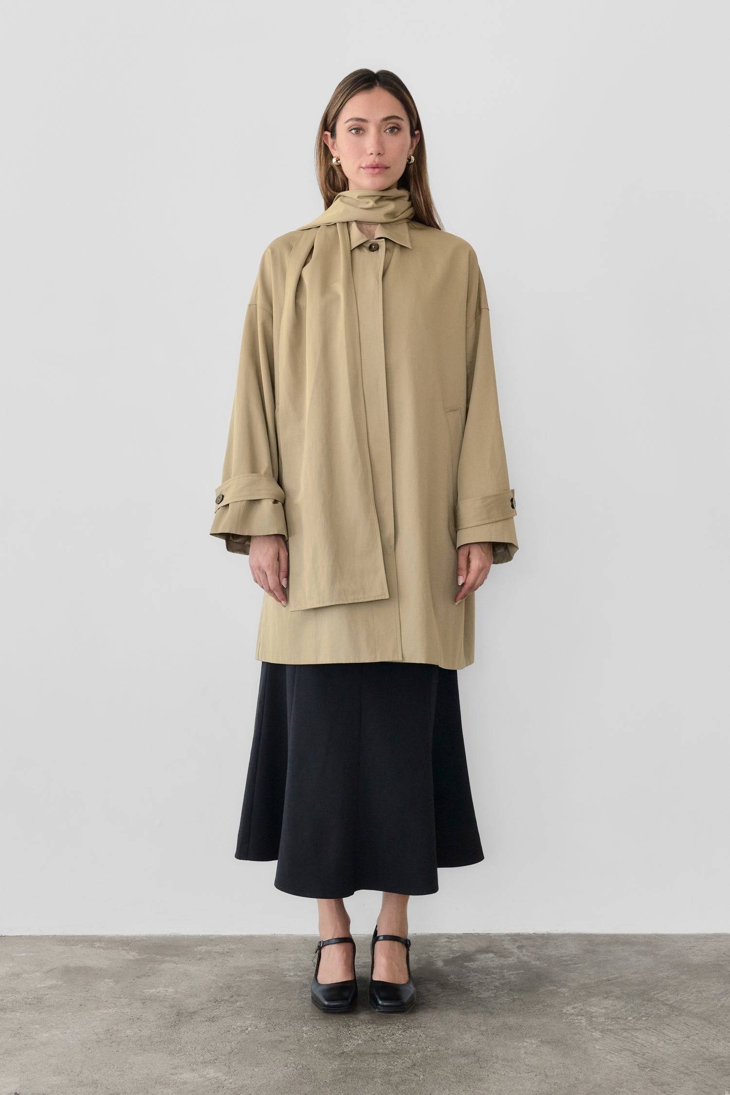 8828669198557, The Cove Coat, Outerwear, Mod Ref, attached scarf,Black,cf-color-black,cf-color-khaki,cf-size-l,cf-size-m,cf-size-s,cf-vendor-mod-ref,Coat,coat jacket,Comfort,Comfortable,Detail,Details,Fall,layer,layering,Layers,Long,Long Sleeve,modref,new,Outerwear,Oversized,Oversized Coat,Peacoat,Pockets,scarf,Spring,Summer,Transitional,Trench,Trench Coat,Womens, Information The Cove Coat offers an effortless chic style. It sits slightly below the hips for a trendy look and includes an attachable scarf for