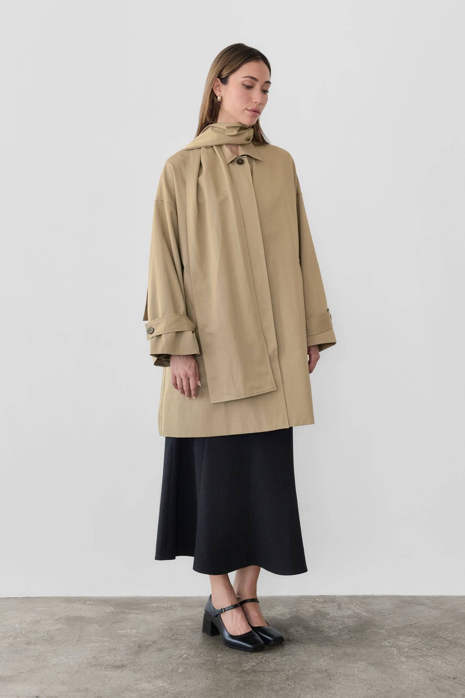 8828669198557, The Cove Coat, Outerwear, Mod Ref, attached scarf,Black,cf-color-black,cf-color-khaki,cf-size-l,cf-size-m,cf-size-s,cf-vendor-mod-ref,Coat,coat jacket,Comfort,Comfortable,Detail,Details,Fall,layer,layering,Layers,Long,Long Sleeve,modref,new,Outerwear,Oversized,Oversized Coat,Peacoat,Pockets,scarf,Spring,Summer,Transitional,Trench,Trench Coat,Womens, Information The Cove Coat offers an effortless chic style. It sits slightly below the hips for a trendy look and includes an attachable scarf for