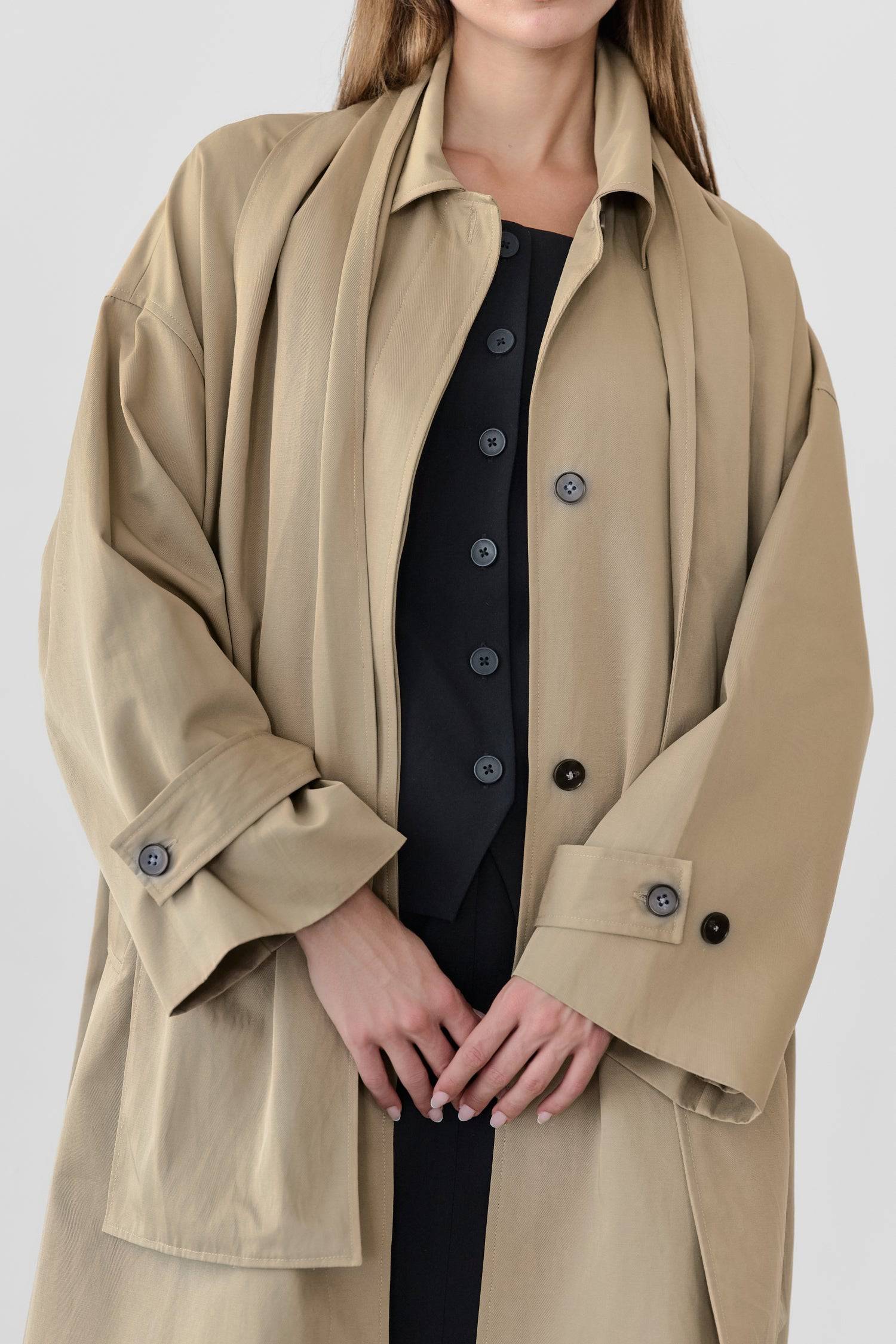 8828669198557, The Cove Coat, Outerwear, Mod Ref, attached scarf,Black,cf-color-black,cf-color-khaki,cf-size-l,cf-size-m,cf-size-s,cf-vendor-mod-ref,Coat,coat jacket,Comfort,Comfortable,Detail,Details,Fall,layer,layering,Layers,Long,Long Sleeve,modref,new,Outerwear,Oversized,Oversized Coat,Peacoat,Pockets,scarf,Spring,Summer,Transitional,Trench,Trench Coat,Womens, Information The Cove Coat offers an effortless chic style. It sits slightly below the hips for a trendy look and includes an attachable scarf for
