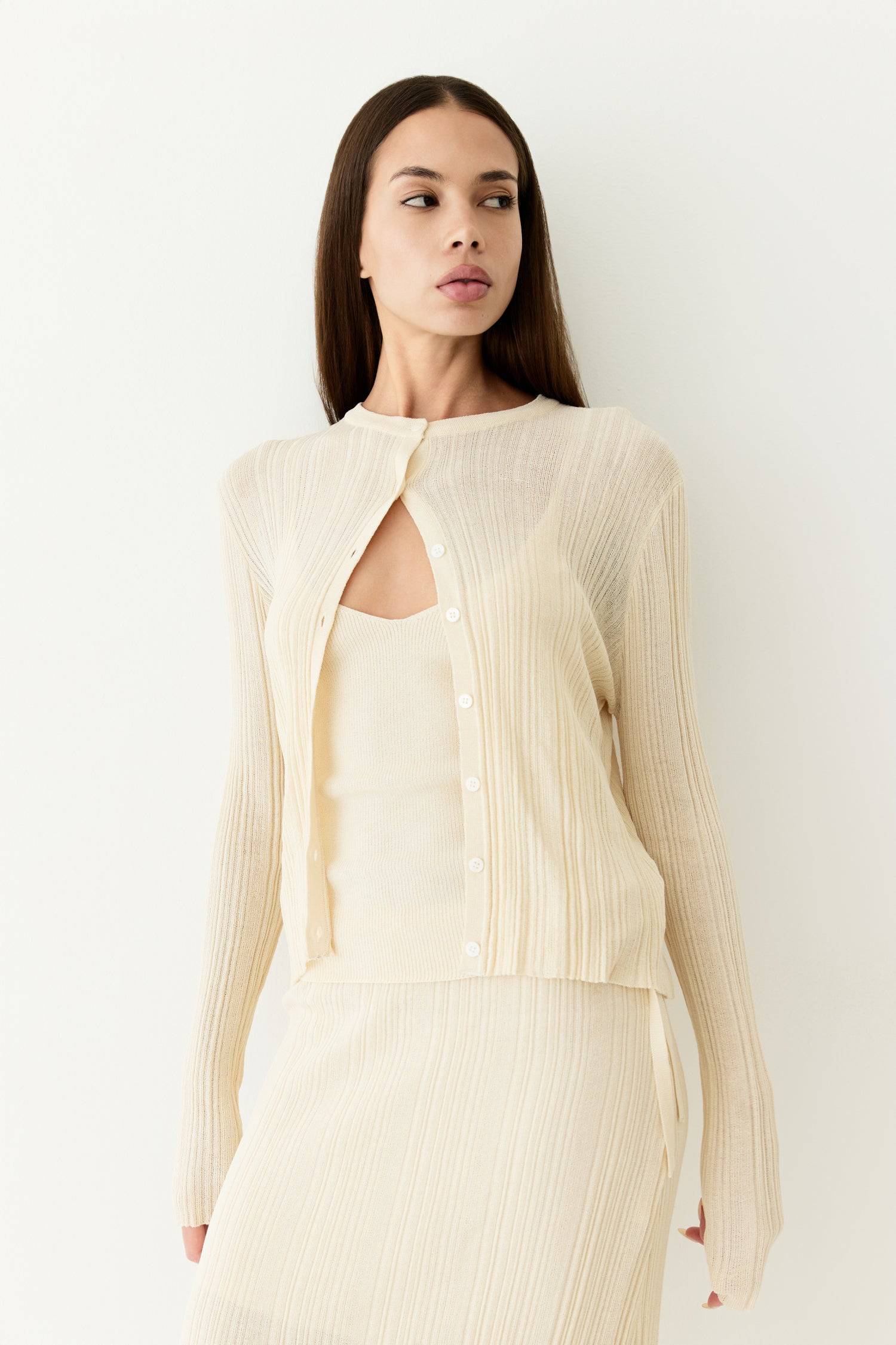 8954055065821, The Trinity Cardigan, Outerwear, Mod Ref, beige,Black,Button up,Cardigan,Casual,cf-color-black,cf-color-cream,cf-size-l,cf-size-m,cf-size-s,cf-size-xl,cf-size-xs,cf-vendor-mod-ref,Cotton,Cream,Knit,Light Blue,Matching Set,Mod Ref,modref,new,Oversized,Pullover,Relaxed,Relaxed Fit,Rib Knit,set,Sets,Soft Knit,tonal,Transitional,Women's, Information The Trinity Cardigan is a duo-style set, featuring a sheer rib-knit cardigan with long sleeves and button-down details, paired with a coordinating ta