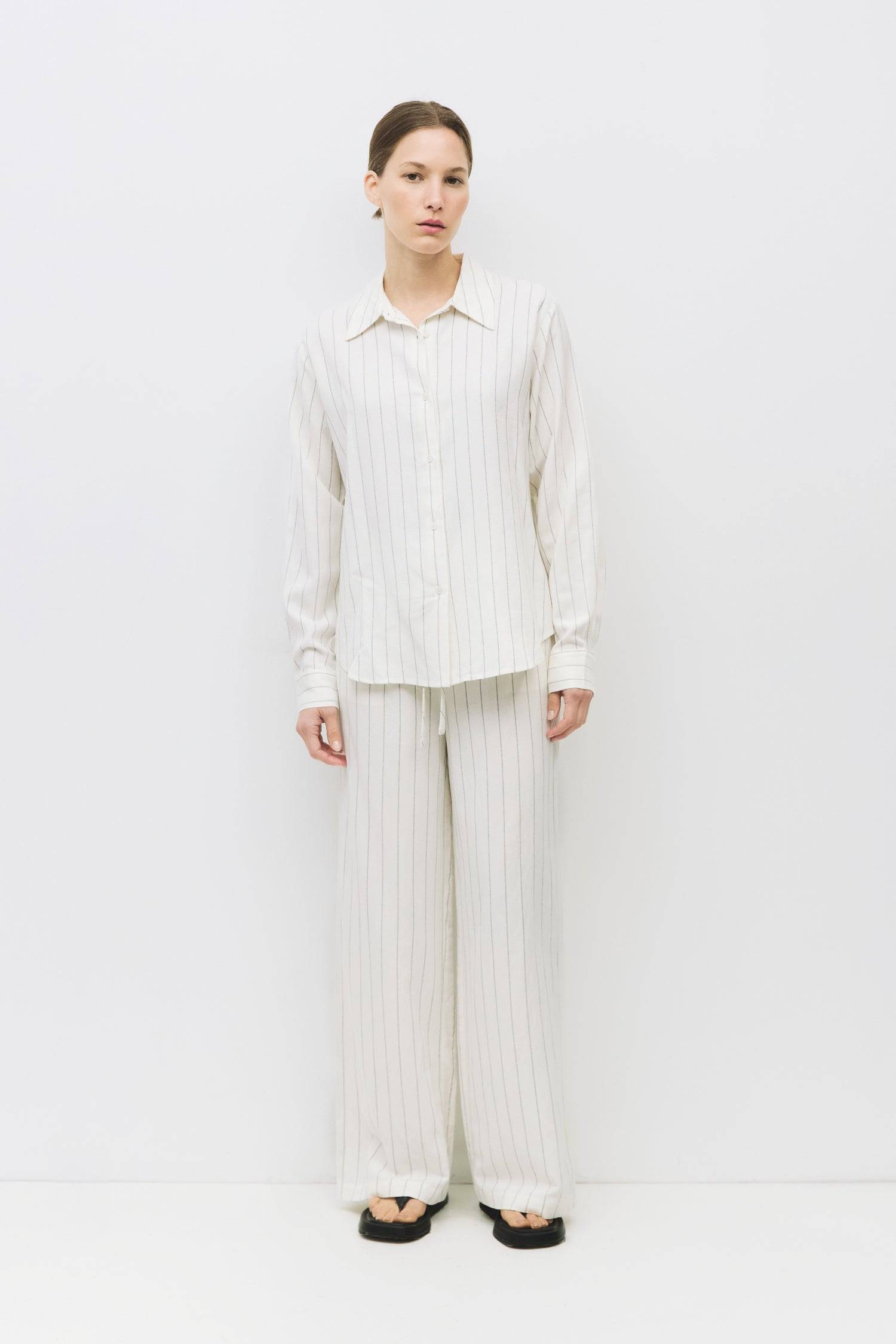 8983687069917, The Raquel Pants, Bottoms, Mod Ref, Basic,Basics,Bottoms,Casual,cf-size-l,cf-size-m,cf-size-s,cf-vendor-mod-ref,Comfortable,Everyday,Front Pocket,Long Pants,mid rise,modref,Pants,Patch Pockets,Pleated,Pockets,Sets,Spring,straight fit,Transitional,white,women,Womens, Information The Raquel Pants are a stylish pinstripe design made from a comfortable linen blend, featuring a front button and zipper closure with an elasticized back waistband for a secure fit. With a separate self-tie belt, side