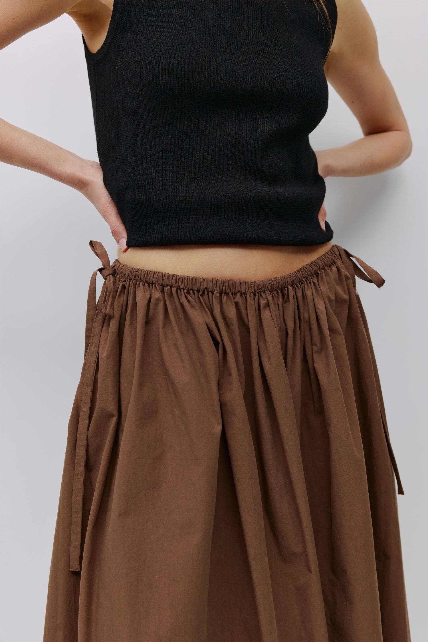 8994991636701, The Kiana Skirt, Bottoms, All Row, Black,Bottom,Bottoms,Breathable,cf-color-black,cf-color-white,cf-color-yellow,cf-size-l,cf-size-m,cf-size-s,cf-vendor-all-row,Comfortable,everyday,High Waist,Midi Skirt,new,Skirt,spring,Summer,versatile,white,womens, Information The Kiana Skirt features adjustable ties on either side of the waist for a customizable fit. Crafted from midweight fabric, it offers a flattering silhouette with a relaxed, effortless vibe. Details 100% Cotton Adjustable Side Waist