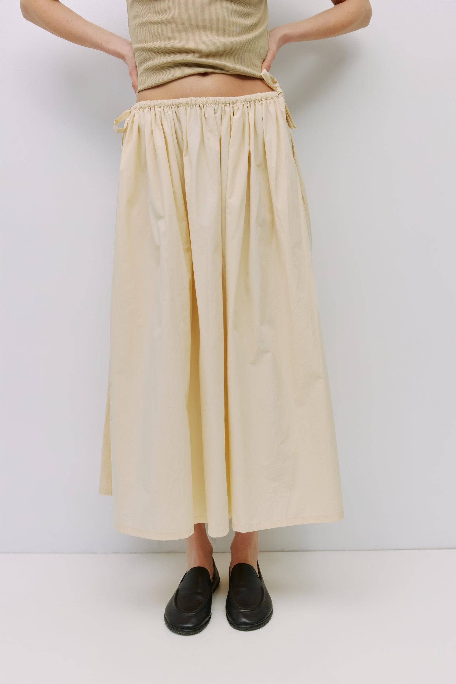8994991636701, The Kiana Skirt, Bottoms, All Row, Black,Bottom,Bottoms,Breathable,cf-color-black,cf-color-white,cf-color-yellow,cf-size-l,cf-size-m,cf-size-s,cf-vendor-all-row,Comfortable,everyday,High Waist,Midi Skirt,new,Skirt,spring,Summer,versatile,white,womens, Information The Kiana Skirt features adjustable ties on either side of the waist for a customizable fit. Crafted from midweight fabric, it offers a flattering silhouette with a relaxed, effortless vibe. Details 100% Cotton Adjustable Side Waist