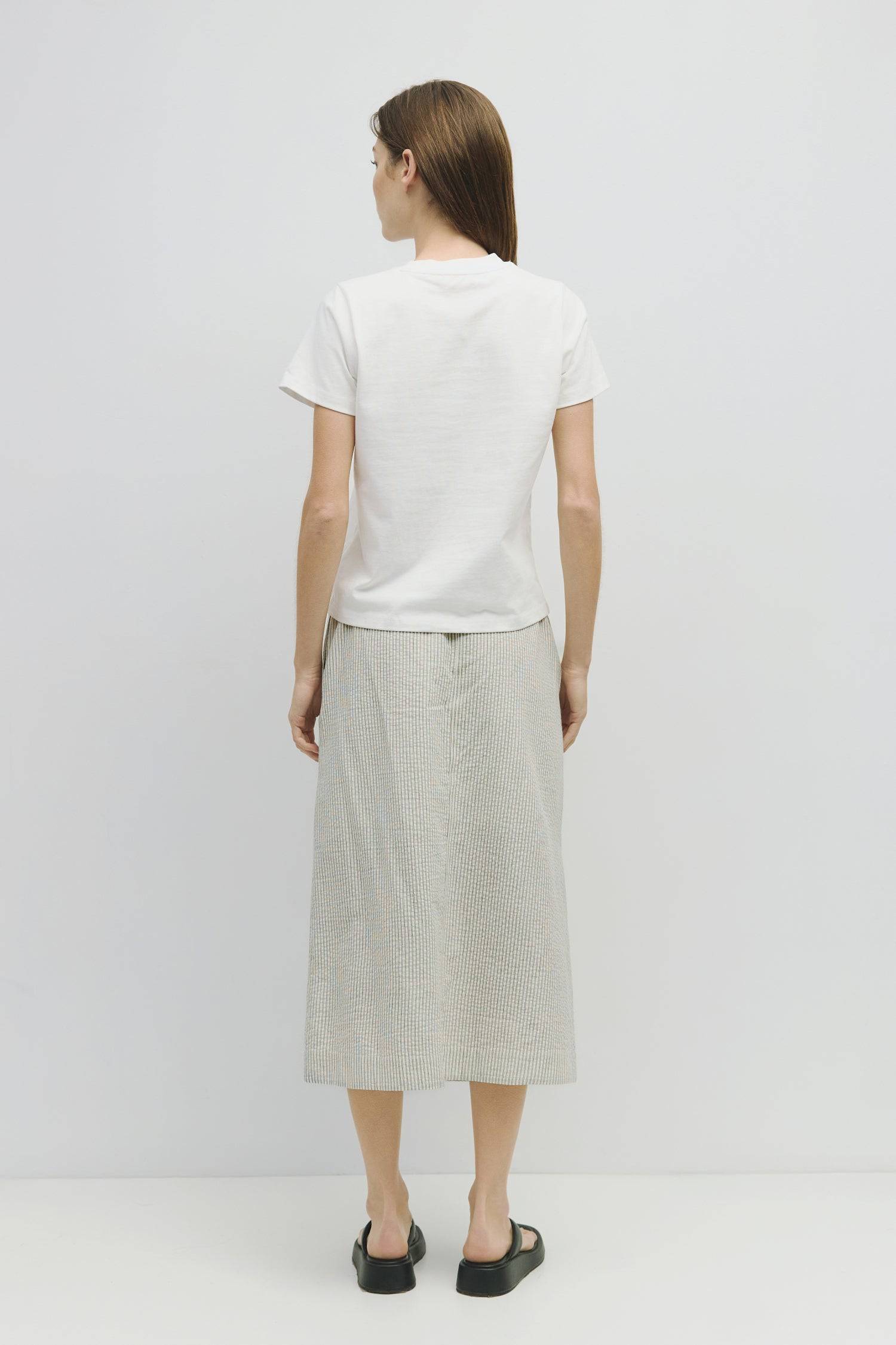 8929228947677, The Genevieve Skirt, Bottoms, Mod Ref, adjustable,Adjustable Cords,Casual,cf-size-l,cf-size-m,cf-size-s,cf-size-xl,cf-size-xs,Comfortable,cotton,Everyday,final-sale,finalsale,Maxi,midi length,Midi Skirt,new,Pinstripes,Pocket,Pockets,Relaxed,Relaxed Fit,sale,seersucker,side pockets,Skirt,Striped,texture,Women's, Information The Genevieve Skirt is a midi-length skirt designed with a lightweight seersucker fabric, featuring an elasticized waistband and front tie for a comfortable fit. With a str