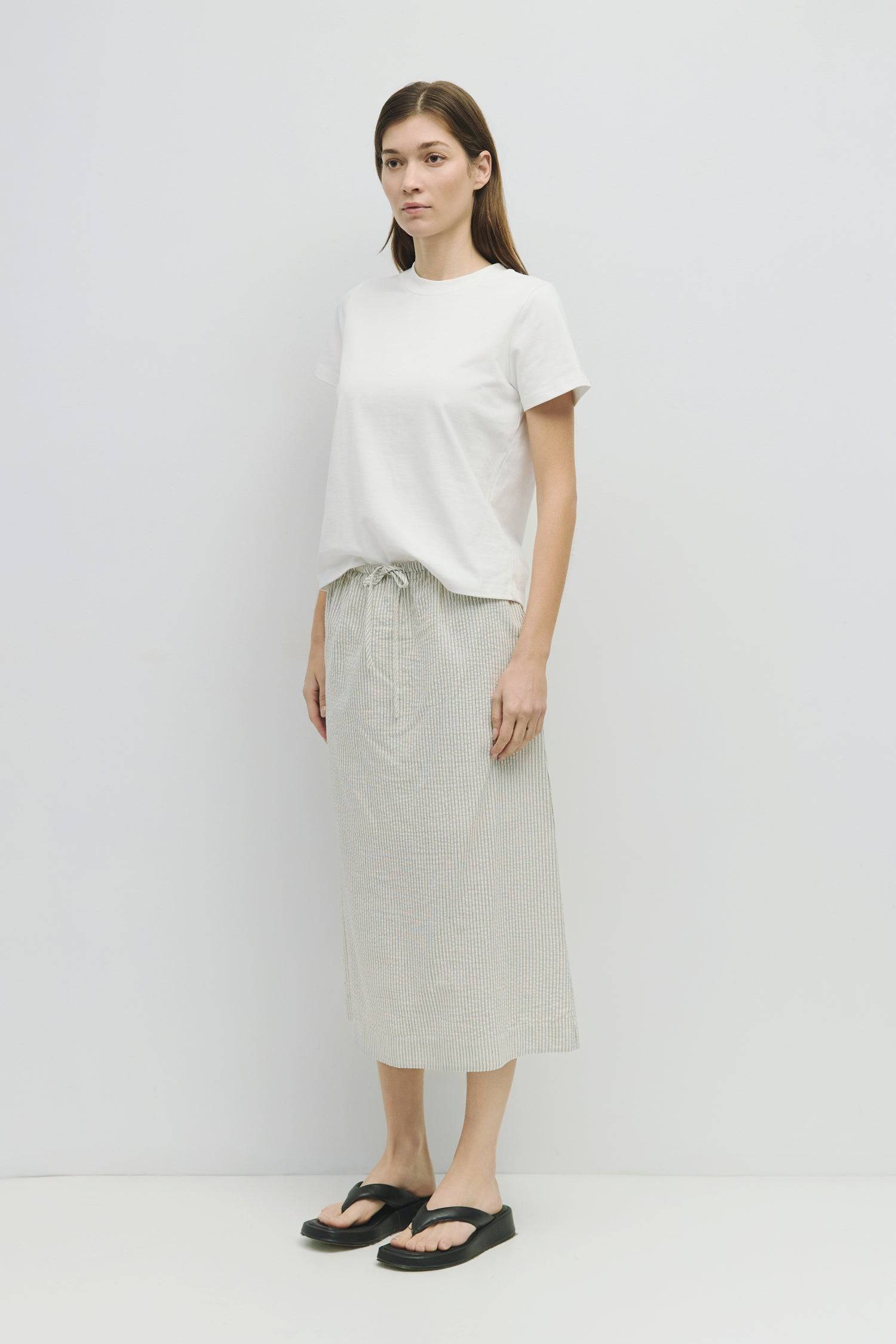 8929228947677, The Genevieve Skirt, Bottoms, Mod Ref, adjustable,Adjustable Cords,Casual,cf-size-l,cf-size-m,cf-size-s,cf-size-xl,cf-size-xs,Comfortable,cotton,Everyday,final-sale,finalsale,Maxi,midi length,Midi Skirt,new,Pinstripes,Pocket,Pockets,Relaxed,Relaxed Fit,sale,seersucker,side pockets,Skirt,Striped,texture,Women's, Information The Genevieve Skirt is a midi-length skirt designed with a lightweight seersucker fabric, featuring an elasticized waistband and front tie for a comfortable fit. With a str