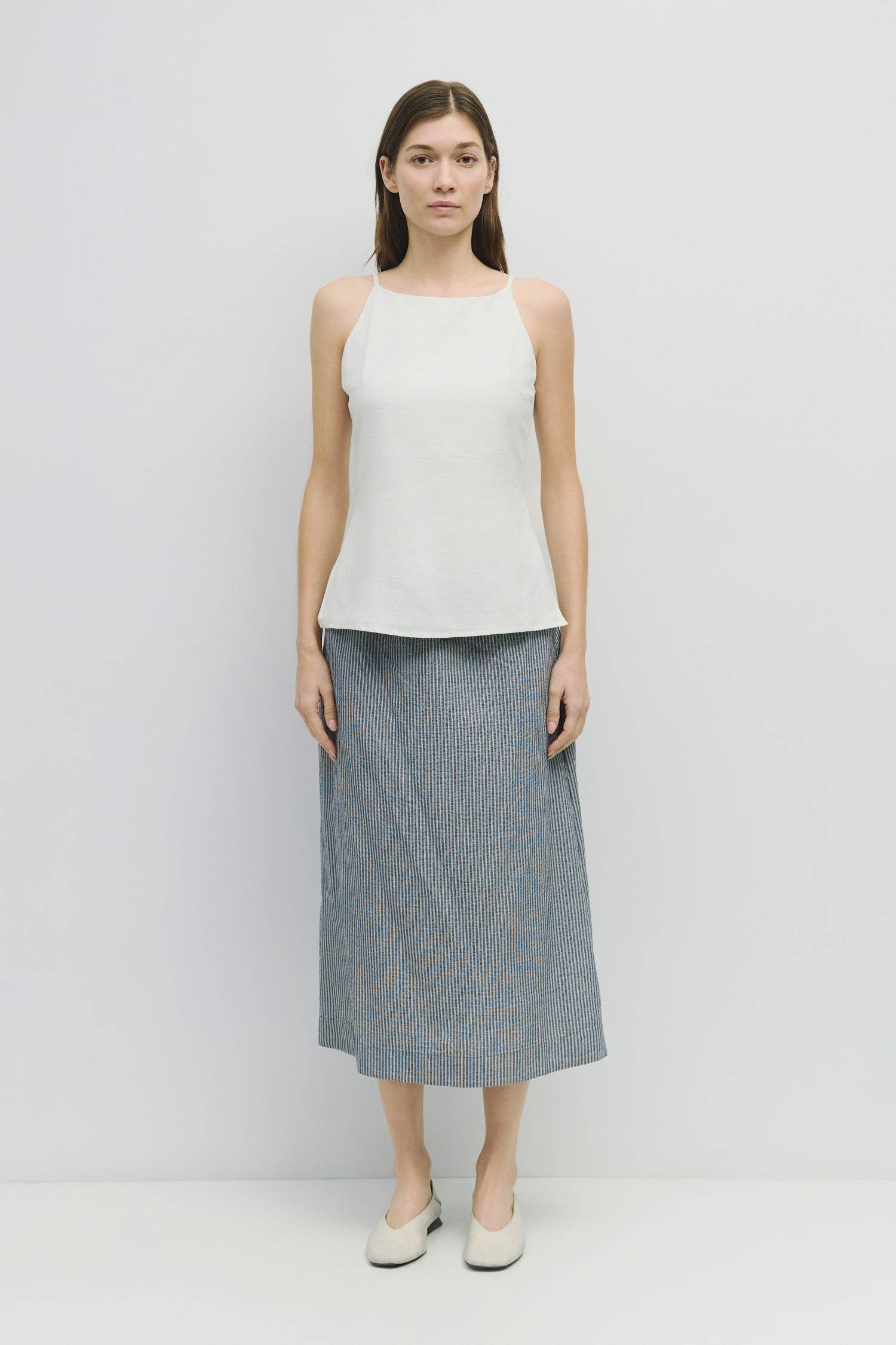8929228947677, The Genevieve Skirt, Bottoms, Mod Ref, adjustable,Adjustable Cords,Casual,cf-size-l,cf-size-m,cf-size-s,cf-size-xl,cf-size-xs,Comfortable,cotton,Everyday,final-sale,finalsale,Maxi,midi length,Midi Skirt,new,Pinstripes,Pocket,Pockets,Relaxed,Relaxed Fit,sale,seersucker,side pockets,Skirt,Striped,texture,Women's, Information The Genevieve Skirt is a midi-length skirt designed with a lightweight seersucker fabric, featuring an elasticized waistband and front tie for a comfortable fit. With a str