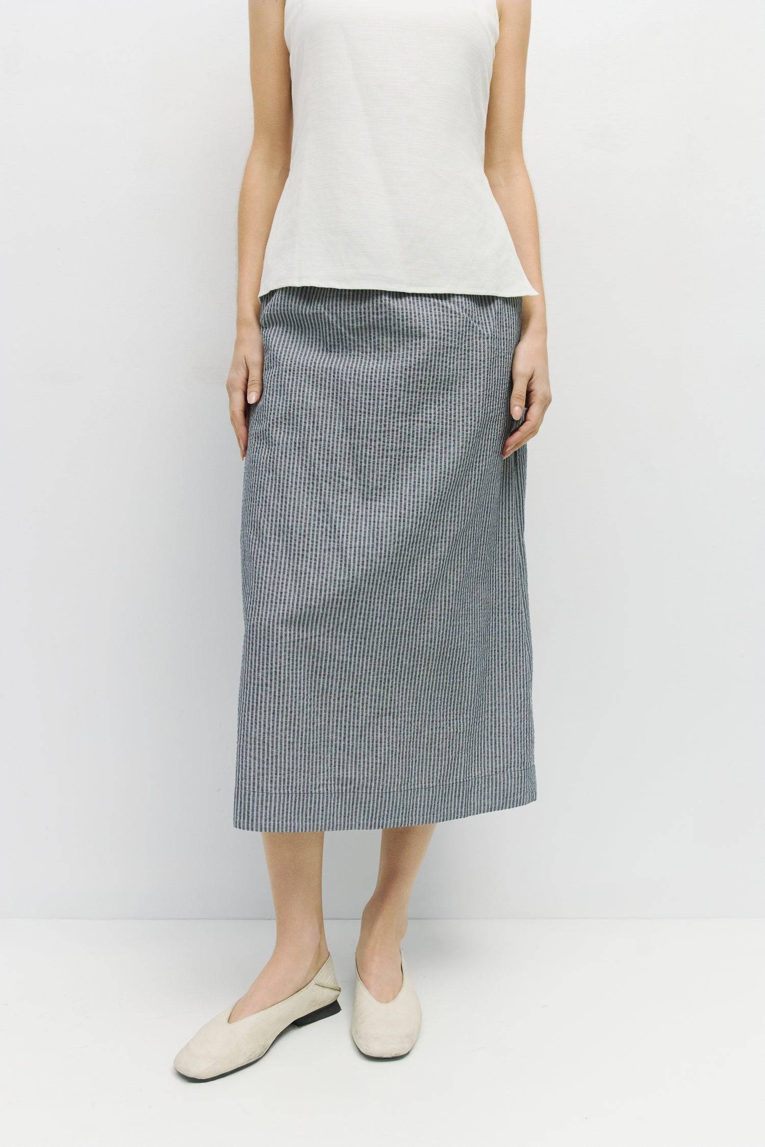 8929228947677, The Genevieve Skirt, Bottoms, Mod Ref, adjustable,Adjustable Cords,Casual,cf-size-l,cf-size-m,cf-size-s,cf-size-xl,cf-size-xs,Comfortable,cotton,Everyday,final-sale,finalsale,Maxi,midi length,Midi Skirt,new,Pinstripes,Pocket,Pockets,Relaxed,Relaxed Fit,sale,seersucker,side pockets,Skirt,Striped,texture,Women's, Information The Genevieve Skirt is a midi-length skirt designed with a lightweight seersucker fabric, featuring an elasticized waistband and front tie for a comfortable fit. With a str