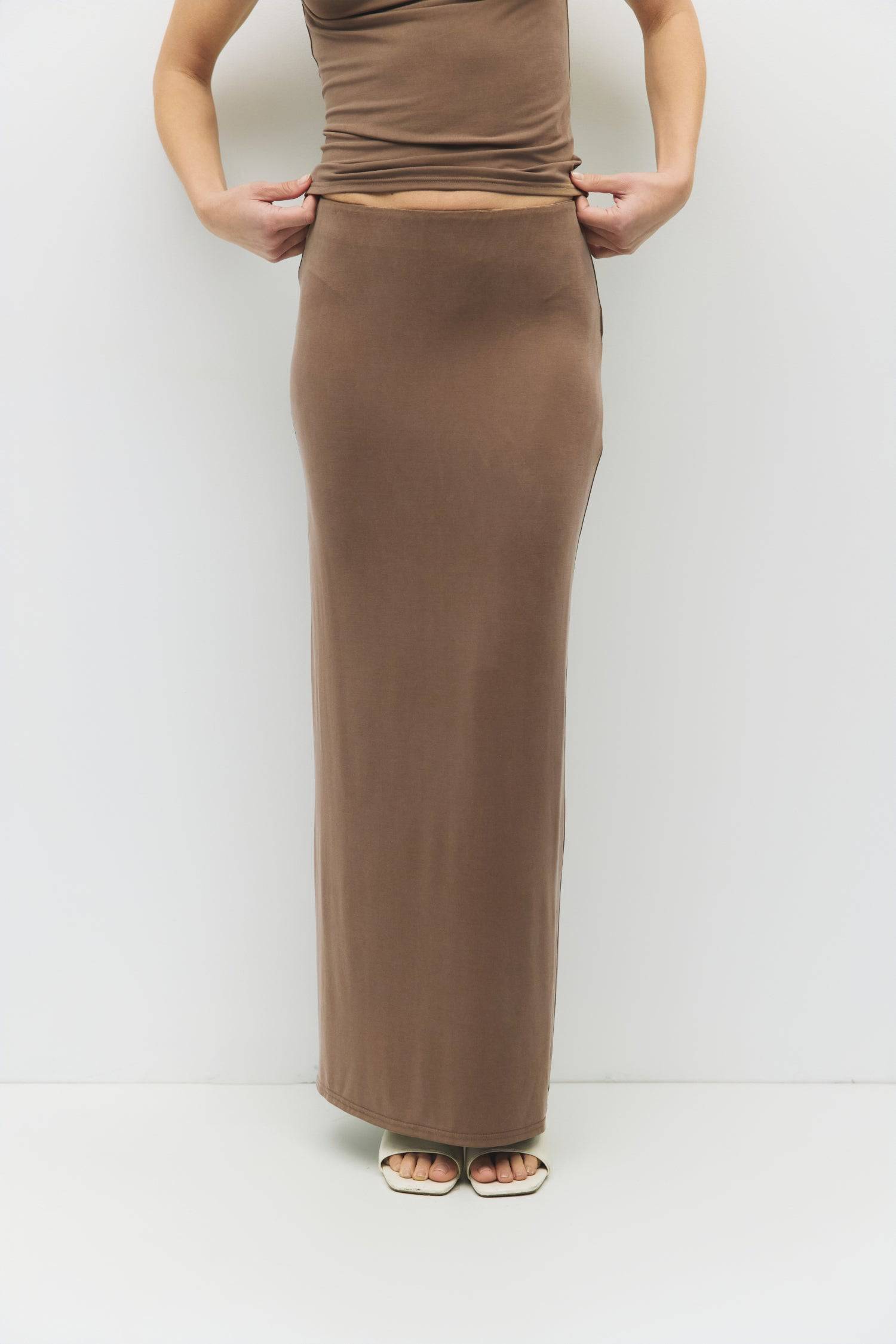 8983730487517, The Amal Skirt, Bottoms, Mod Ref, Black,Bottom,Bottoms,Casual,cf-color-black,cf-color-cream,cf-size-l,cf-size-m,cf-size-s,cf-vendor-mod-ref,Comfortable,Cotton,Cream,curve skirt,drawstring waist,Dress,Everyday,Form Fitting,Linen,linen-blend,maxi skirt,Midi Dress,midi length,new,Rib Knit,Ribbed,Sleeveless,Spring,Summer,womens, Information The Amal Skirt is a fitted, pull-on modal knit maxi skirt with a straight silhouette and a back vent for ease of movement. With an elasticized waistband and b