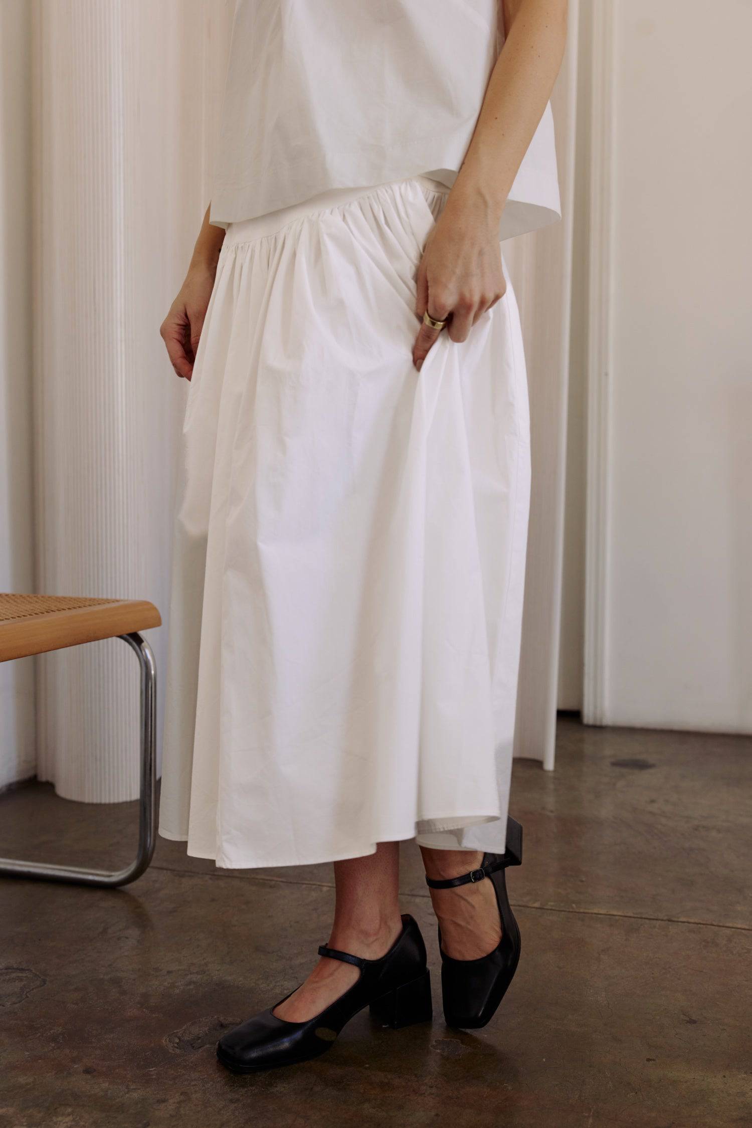 8302393393373, The Mariana Skirt, Bottoms, All Row, beige,Black,Bottom,Bottoms,Breathable,cf-color-black,cf-color-white,cf-size-l,cf-size-m,cf-size-s,cf-vendor-all-row,Comfortable,everyday,flowy,High Waist,Lime,Matching Set,Midi Skirt,POPLIN,Relaxed Fit,ruched,ruching,Semi-Formal,set,Sets,Skirt,spring,Summer,versatile,white,womens, Information The Mariana Skirt is an elevated midi skirt with wrap detailing at the waistline. It features a full, flowing design and an invisible back zipper for a seamless finis