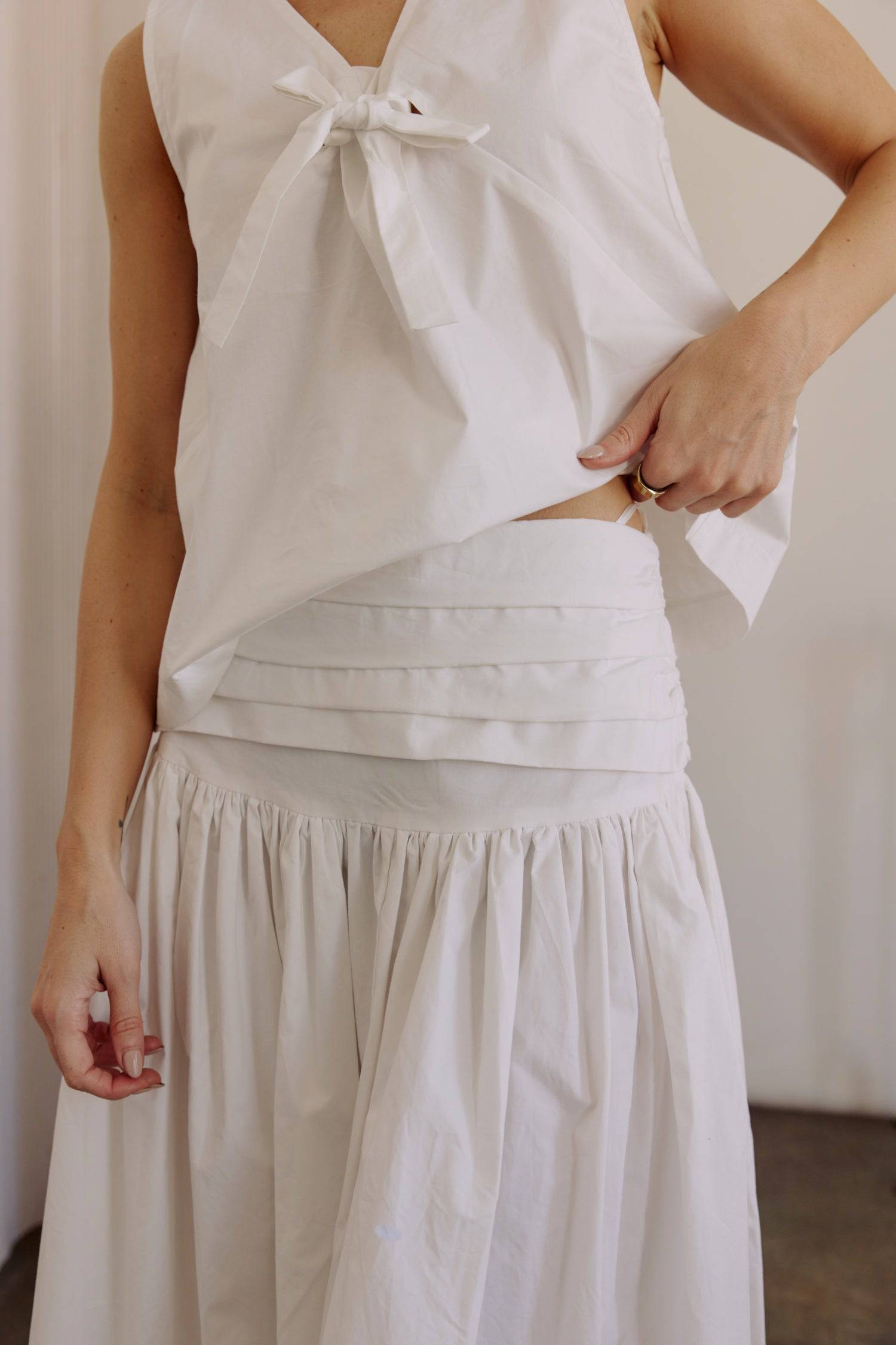 8302393393373, The Mariana Skirt, Bottoms, All Row, beige,Black,Bottom,Bottoms,Breathable,cf-color-black,cf-color-white,cf-size-l,cf-size-m,cf-size-s,cf-vendor-all-row,Comfortable,everyday,flowy,High Waist,Lime,Matching Set,Midi Skirt,POPLIN,Relaxed Fit,ruched,ruching,Semi-Formal,set,Sets,Skirt,spring,Summer,versatile,white,womens, Information The Mariana Skirt is an elevated midi skirt with wrap detailing at the waistline. It features a full, flowing design and an invisible back zipper for a seamless finis