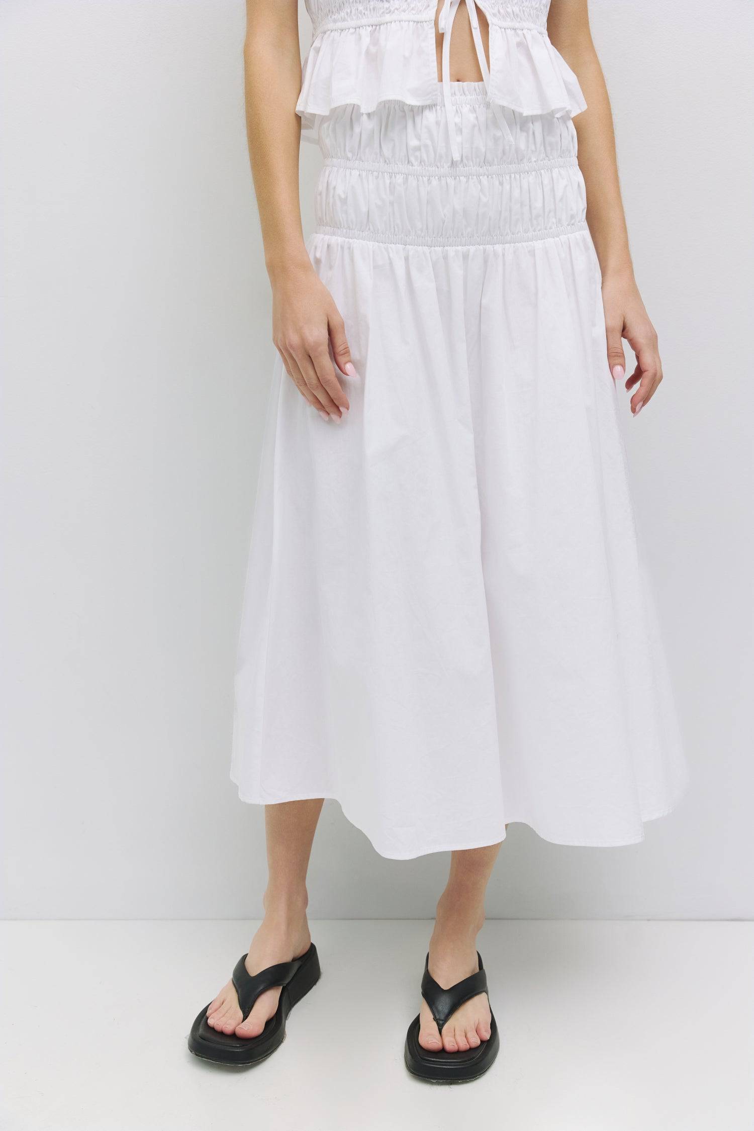 8929245167837, The Natasha Skirt, Bottoms, All Row, Black,Bottom,Bottoms,Breathable,cf-color-black,cf-color-white,cf-color-yellow,cf-size-l,cf-size-m,cf-size-s,cf-vendor-all-row,Comfortable,everyday,flowy,High Waist,Lime,Matching Set,Midi Skirt,new,POPLIN,Relaxed Fit,ruched,ruching,Semi-Formal,set,Sets,Skirt,spring,Summer,versatile,white,womens,Yellow, Information The Natasha Skirt is a comfortable midi-length skirt featuring a triple elasticized waistband and stylish paneled shirring detail at the waistlin