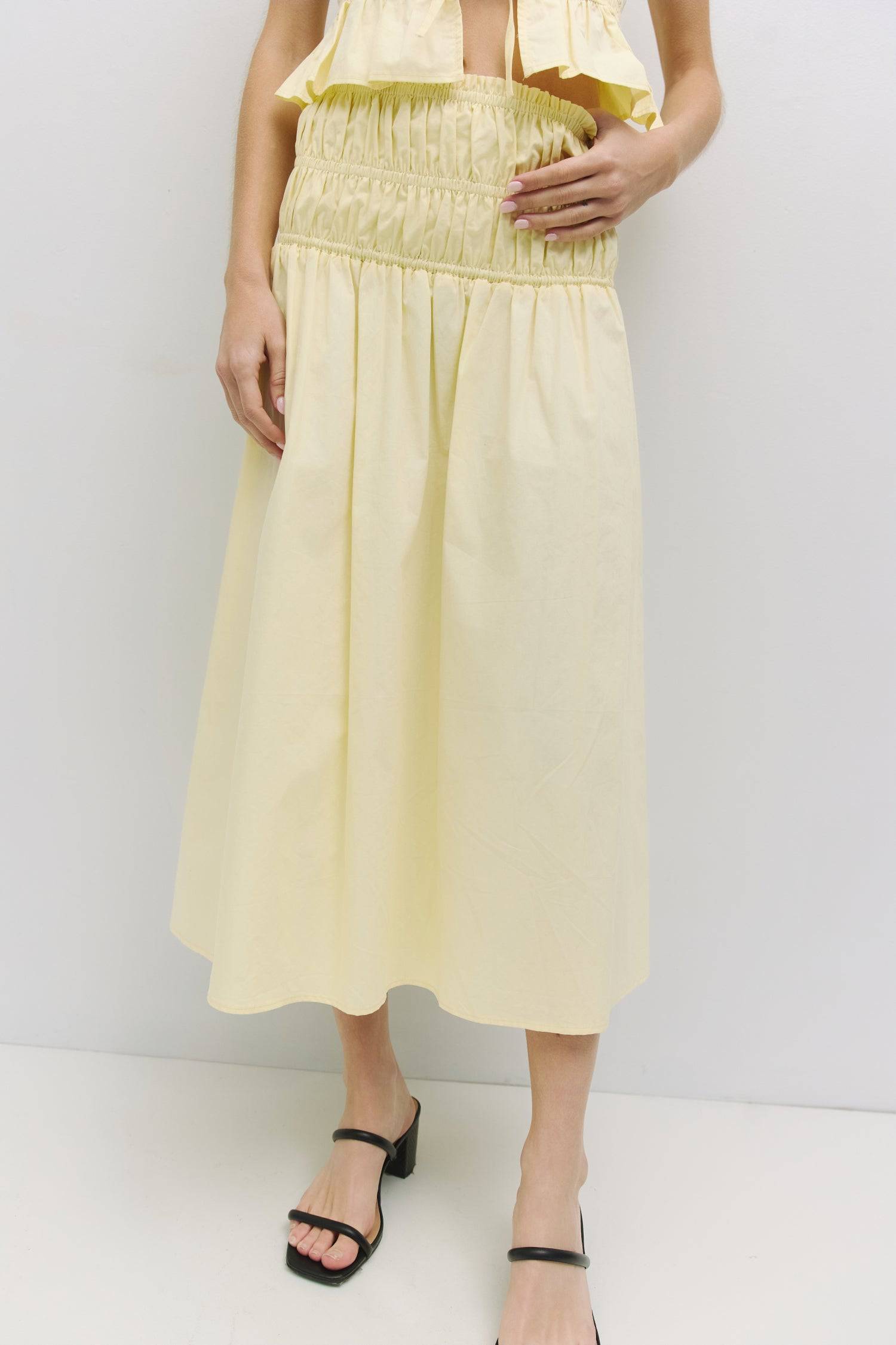 8929245167837, The Natasha Skirt, Bottoms, All Row, Black,Bottom,Bottoms,Breathable,cf-color-black,cf-color-white,cf-color-yellow,cf-size-l,cf-size-m,cf-size-s,cf-vendor-all-row,Comfortable,everyday,flowy,High Waist,Lime,Matching Set,Midi Skirt,new,POPLIN,Relaxed Fit,ruched,ruching,Semi-Formal,set,Sets,Skirt,spring,Summer,versatile,white,womens,Yellow, Information The Natasha Skirt is a comfortable midi-length skirt featuring a triple elasticized waistband and stylish paneled shirring detail at the waistlin