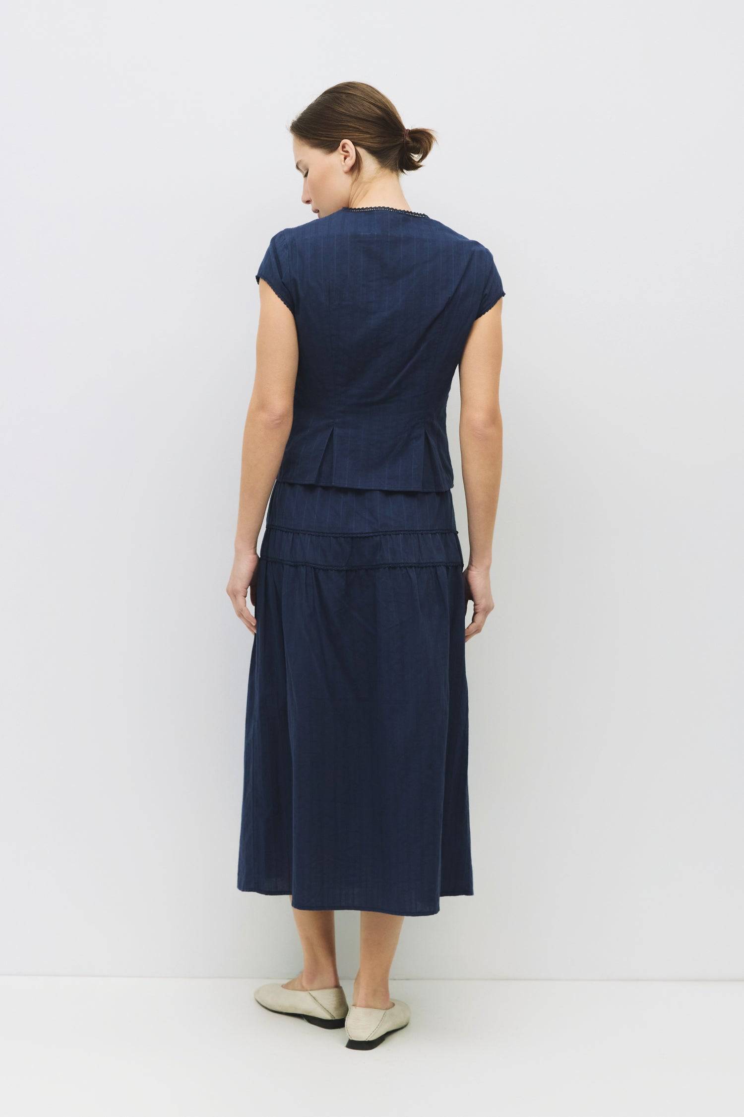 8983694868701, The Keaton Skirt, Bottoms, All Row, Black,Bottom,Bottoms,Casual,cf-color-black,cf-color-cream,cf-size-l,cf-size-m,cf-size-s,cf-vendor-mod-ref,Comfortable,Cotton,Cream,curve skirt,drawstring waist,Dress,Everyday,final-sale,finalsale,Form Fitting,Linen,linen-blend,maxi skirt,Midi Dress,midi length,new,Rib Knit,Ribbed,sale,Sleeveless,Spring,Summer,womens, Information The Keaton Skirt is a midi-length skirt with an elasticized waistband and adjustable ties. Finished with delicate lace trim and a