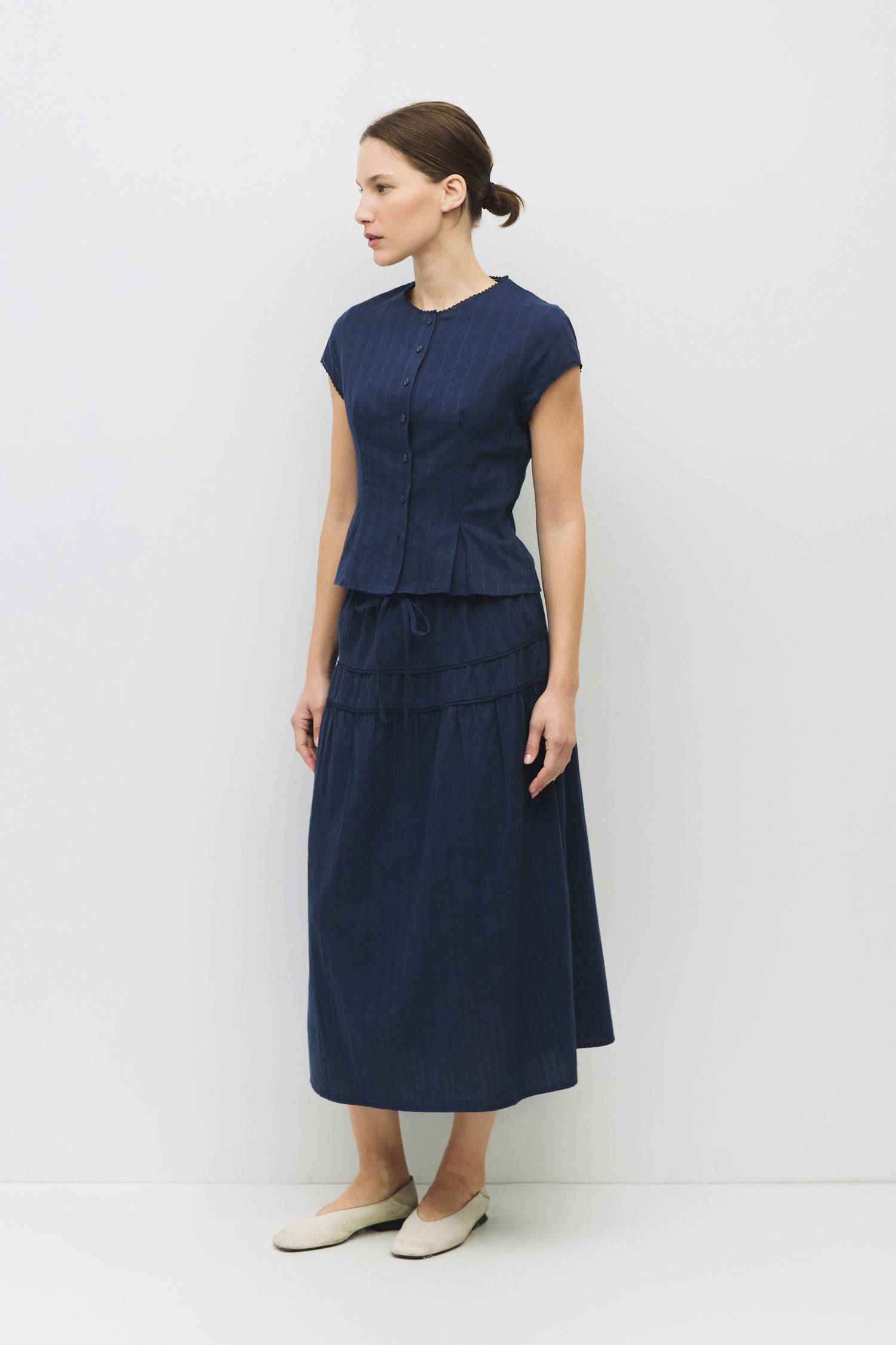 8983694868701, The Keaton Skirt, Bottoms, All Row, Black,Bottom,Bottoms,Casual,cf-color-black,cf-color-cream,cf-size-l,cf-size-m,cf-size-s,cf-vendor-mod-ref,Comfortable,Cotton,Cream,curve skirt,drawstring waist,Dress,Everyday,final-sale,finalsale,Form Fitting,Linen,linen-blend,maxi skirt,Midi Dress,midi length,new,Rib Knit,Ribbed,sale,Sleeveless,Spring,Summer,womens, Information The Keaton Skirt is a midi-length skirt with an elasticized waistband and adjustable ties. Finished with delicate lace trim and a