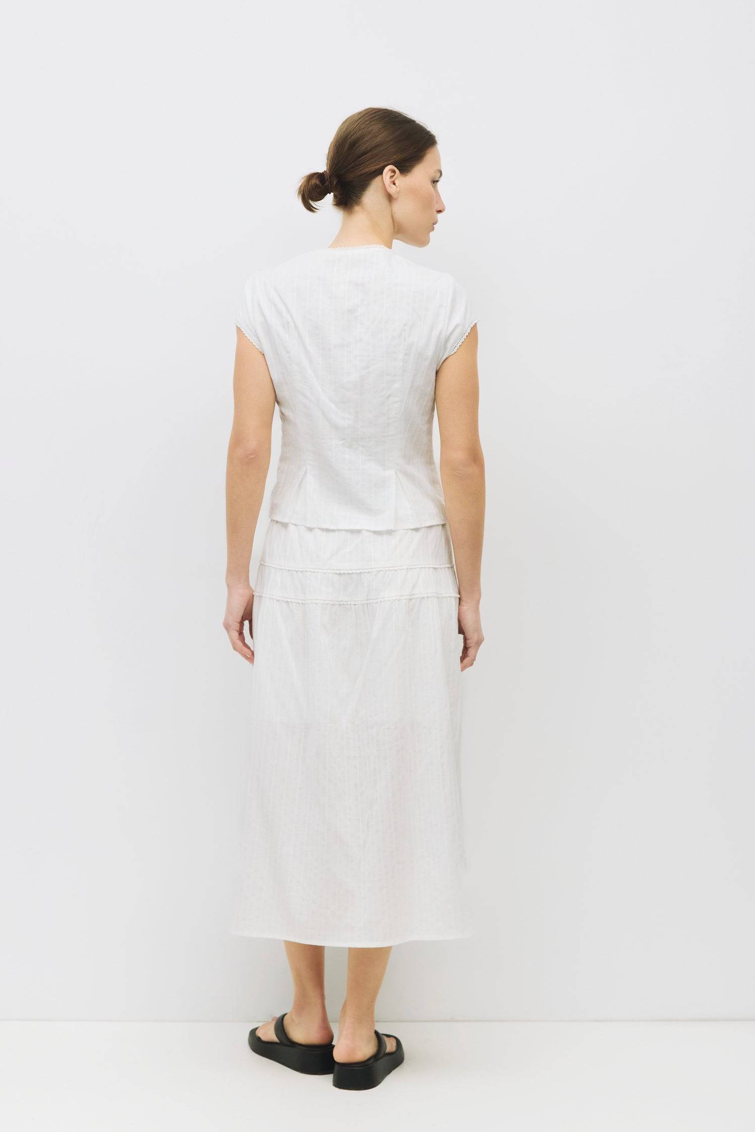 8983694868701, The Keaton Skirt, Bottoms, All Row, Black,Bottom,Bottoms,Casual,cf-color-black,cf-color-cream,cf-size-l,cf-size-m,cf-size-s,cf-vendor-mod-ref,Comfortable,Cotton,Cream,curve skirt,drawstring waist,Dress,Everyday,final-sale,finalsale,Form Fitting,Linen,linen-blend,maxi skirt,Midi Dress,midi length,new,Rib Knit,Ribbed,sale,Sleeveless,Spring,Summer,womens, Information The Keaton Skirt is a midi-length skirt with an elasticized waistband and adjustable ties. Finished with delicate lace trim and a