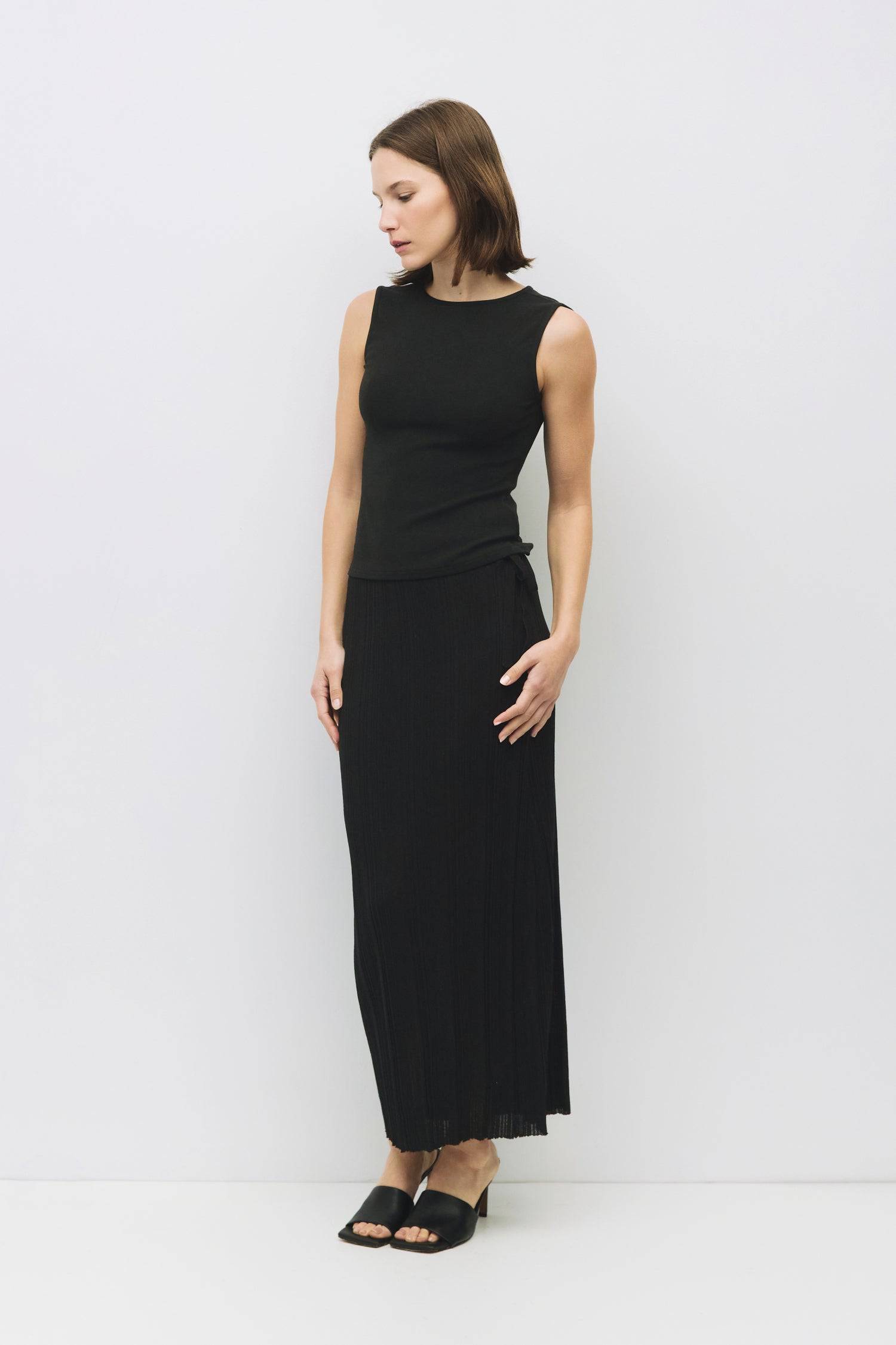 8983696900317, The Kailey Top, Tops, All Row, adjustable,adjustable ties,Black,brown,Casual,cf-color-brown,cf-color-cream,cf-color-olive,cf-size-l,cf-size-m,cf-size-s,cf-size-xl,cf-vendor-all-row,Comfortable,Cream,Crew Neckline,Everyday,flowy,Front Tie,Layers,Lightweight,Minimal,new,Relaxed,Relaxed Fit,Soft,Spring,Top,Trendy,Women's, Information The Kailey Top is a fitted sleeveless knit top with a boat neckline and a semi cut-out detail on the back, finished with a self tie. Its sleek design offers a moder