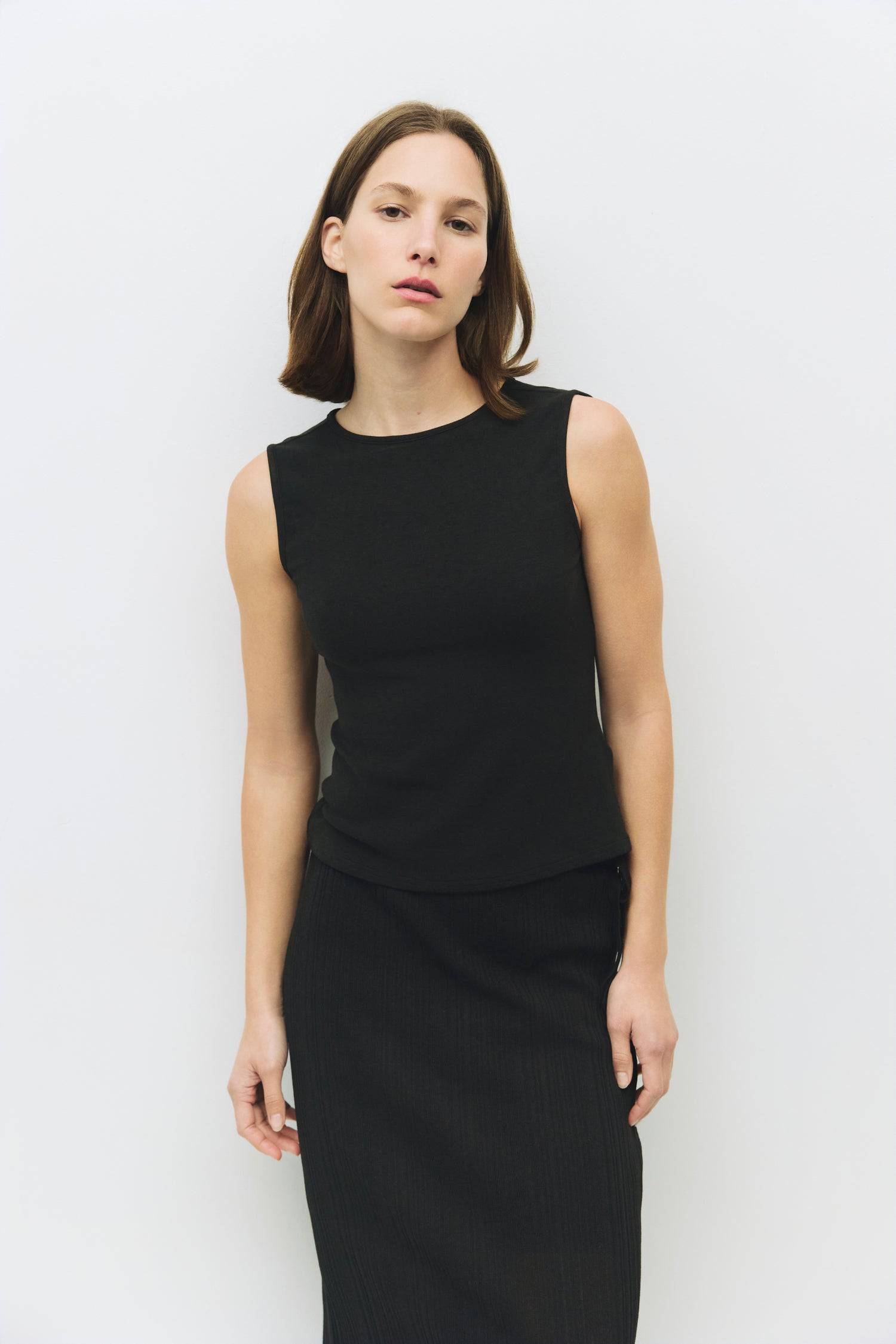 8983696900317, The Kailey Top, Tops, All Row, adjustable,adjustable ties,Black,brown,Casual,cf-color-brown,cf-color-cream,cf-color-olive,cf-size-l,cf-size-m,cf-size-s,cf-size-xl,cf-vendor-all-row,Comfortable,Cream,Crew Neckline,Everyday,flowy,Front Tie,Layers,Lightweight,Minimal,new,Relaxed,Relaxed Fit,Soft,Spring,Top,Trendy,Women's, Information The Kailey Top is a fitted sleeveless knit top with a boat neckline and a semi cut-out detail on the back, finished with a self tie. Its sleek design offers a moder