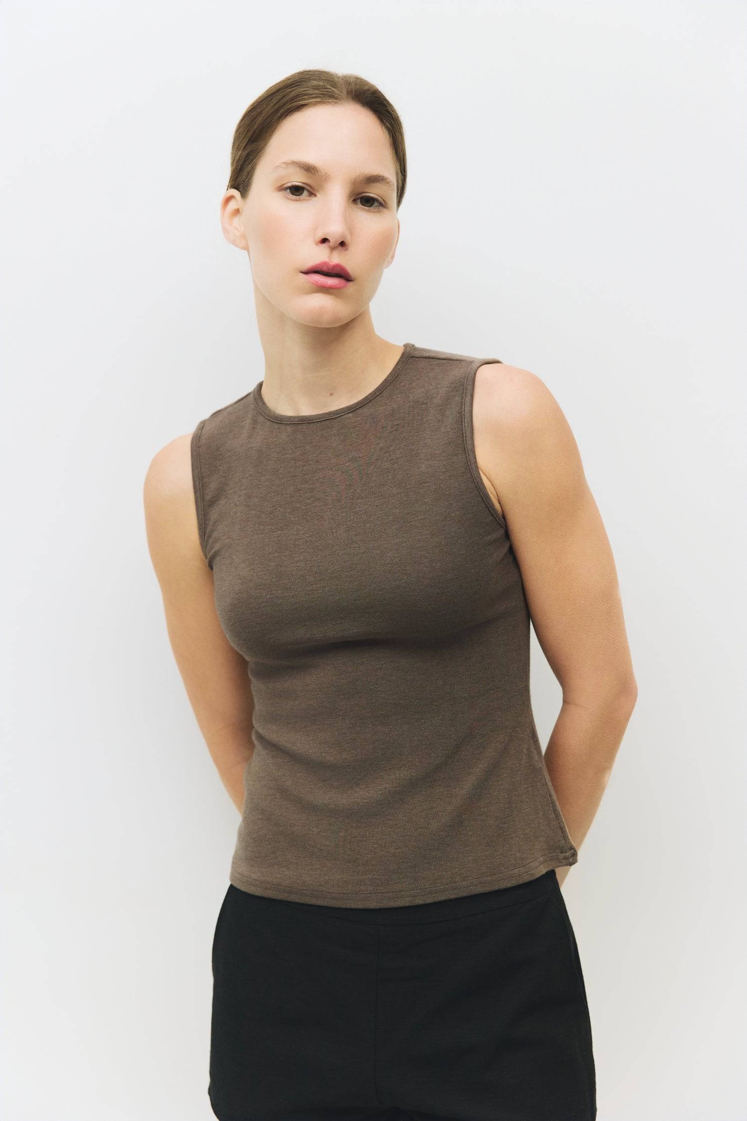 8983696900317, The Kailey Top, Tops, All Row, adjustable,adjustable ties,Black,brown,Casual,cf-color-brown,cf-color-cream,cf-color-olive,cf-size-l,cf-size-m,cf-size-s,cf-size-xl,cf-vendor-all-row,Comfortable,Cream,Crew Neckline,Everyday,flowy,Front Tie,Layers,Lightweight,Minimal,new,Relaxed,Relaxed Fit,Soft,Spring,Top,Trendy,Women's, Information The Kailey Top is a fitted sleeveless knit top with a boat neckline and a semi cut-out detail on the back, finished with a self tie. Its sleek design offers a moder