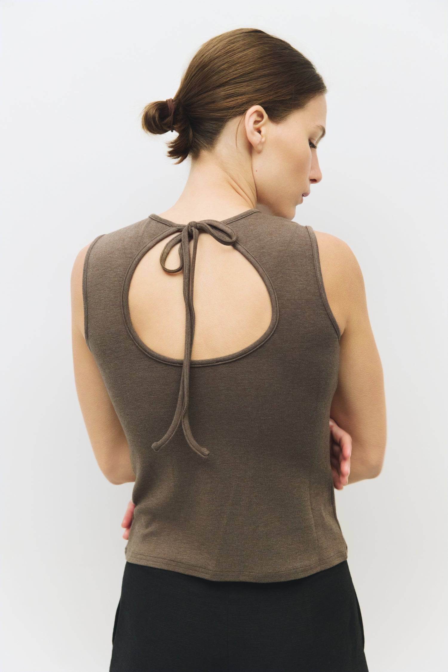 8983696900317, The Kailey Top, Tops, All Row, adjustable,adjustable ties,Black,brown,Casual,cf-color-brown,cf-color-cream,cf-color-olive,cf-size-l,cf-size-m,cf-size-s,cf-size-xl,cf-vendor-all-row,Comfortable,Cream,Crew Neckline,Everyday,flowy,Front Tie,Layers,Lightweight,Minimal,new,Relaxed,Relaxed Fit,Soft,Spring,Top,Trendy,Women's, Information The Kailey Top is a fitted sleeveless knit top with a boat neckline and a semi cut-out detail on the back, finished with a self tie. Its sleek design offers a moder