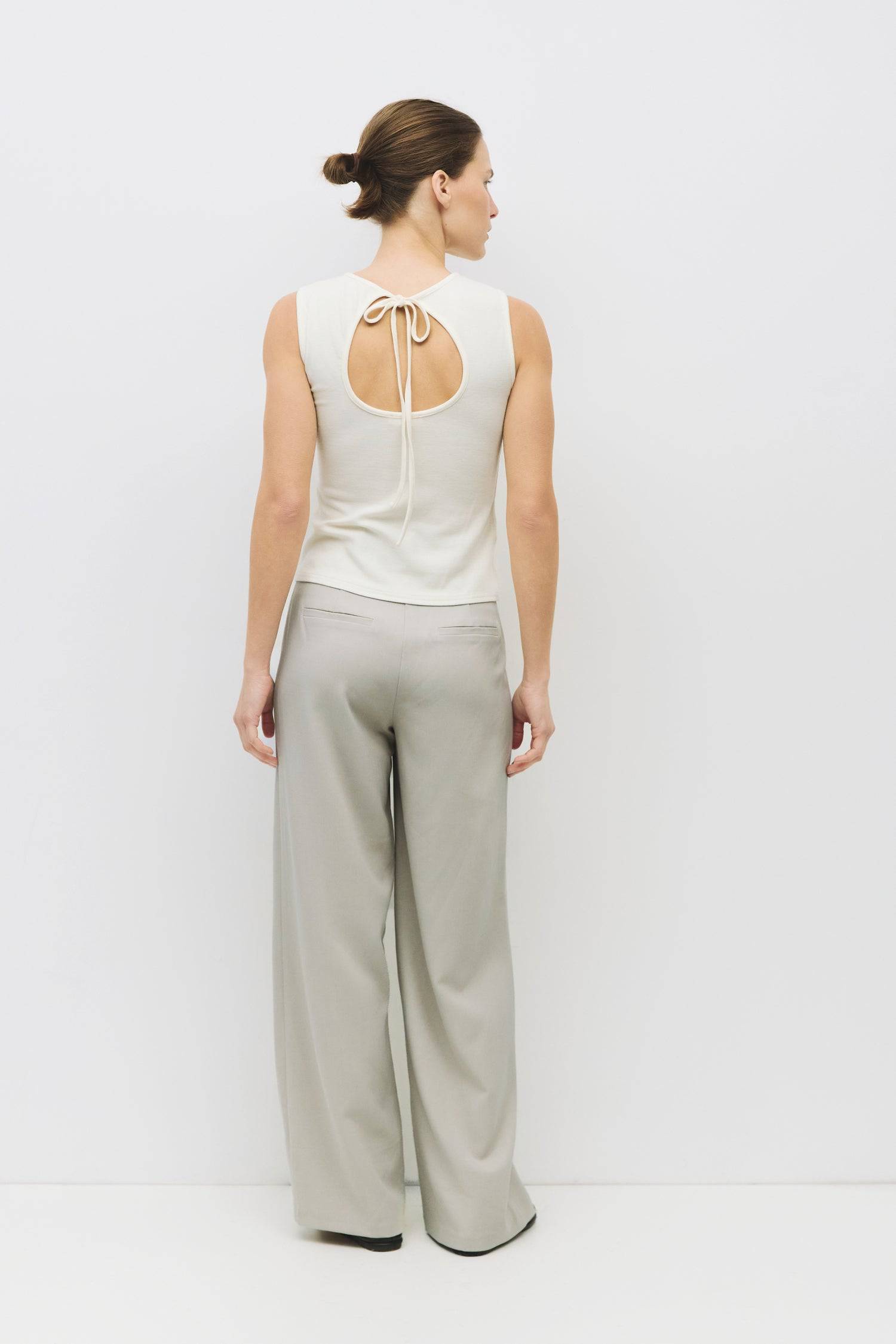 8983696900317, The Kailey Top, Tops, All Row, adjustable,adjustable ties,Black,brown,Casual,cf-color-brown,cf-color-cream,cf-color-olive,cf-size-l,cf-size-m,cf-size-s,cf-size-xl,cf-vendor-all-row,Comfortable,Cream,Crew Neckline,Everyday,flowy,Front Tie,Layers,Lightweight,Minimal,new,Relaxed,Relaxed Fit,Soft,Spring,Top,Trendy,Women's, Information The Kailey Top is a fitted sleeveless knit top with a boat neckline and a semi cut-out detail on the back, finished with a self tie. Its sleek design offers a moder