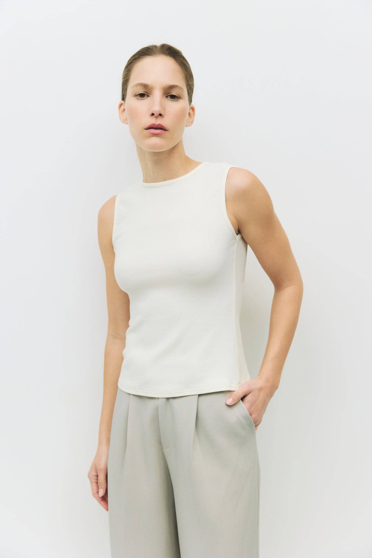 8983696900317, The Kailey Top, Tops, All Row, adjustable,adjustable ties,Black,brown,Casual,cf-color-brown,cf-color-cream,cf-color-olive,cf-size-l,cf-size-m,cf-size-s,cf-size-xl,cf-vendor-all-row,Comfortable,Cream,Crew Neckline,Everyday,flowy,Front Tie,Layers,Lightweight,Minimal,new,Relaxed,Relaxed Fit,Soft,Spring,Top,Trendy,Women's, Information The Kailey Top is a fitted sleeveless knit top with a boat neckline and a semi cut-out detail on the back, finished with a self tie. Its sleek design offers a moder