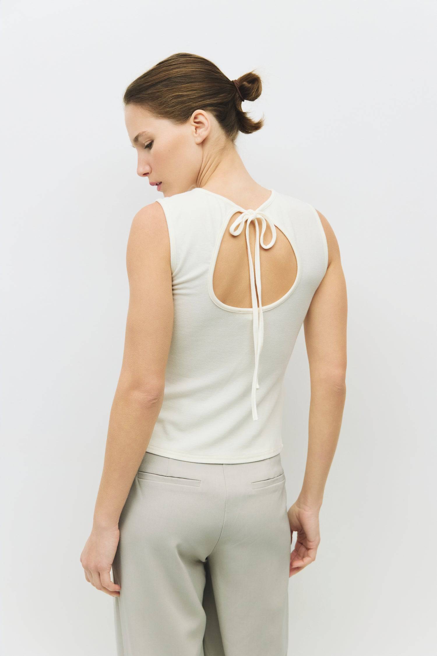 8983696900317, The Kailey Top, Tops, All Row, adjustable,adjustable ties,Black,brown,Casual,cf-color-brown,cf-color-cream,cf-color-olive,cf-size-l,cf-size-m,cf-size-s,cf-size-xl,cf-vendor-all-row,Comfortable,Cream,Crew Neckline,Everyday,flowy,Front Tie,Layers,Lightweight,Minimal,new,Relaxed,Relaxed Fit,Soft,Spring,Top,Trendy,Women's, Information The Kailey Top is a fitted sleeveless knit top with a boat neckline and a semi cut-out detail on the back, finished with a self tie. Its sleek design offers a moder