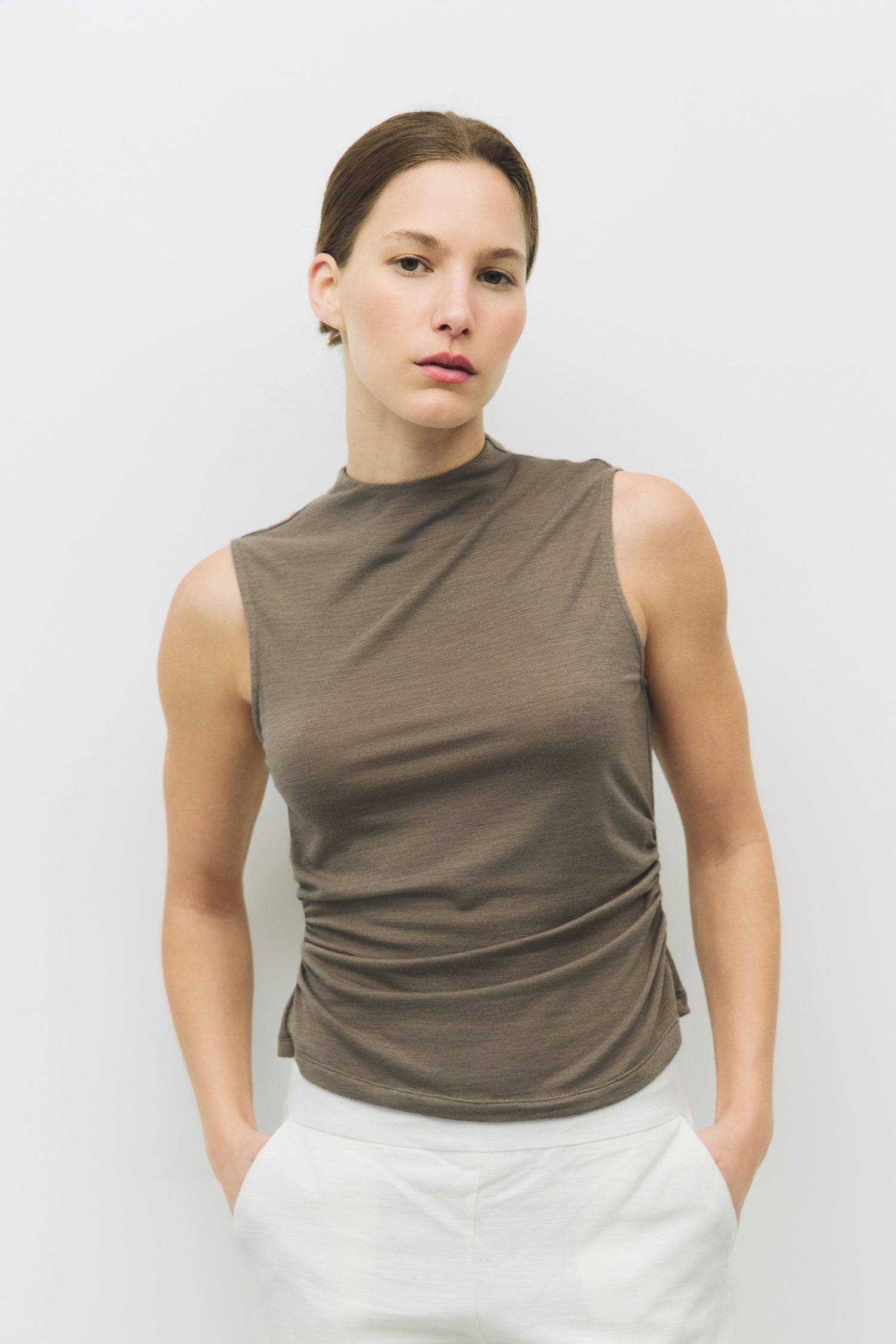 8983698866397, The Genesis Top, Tops, All Row, adjustable,adjustable ties,Black,brown,Casual,cf-color-brown,cf-color-cream,cf-color-olive,cf-size-l,cf-size-m,cf-size-s,cf-size-xl,cf-vendor-all-row,Comfortable,Cream,Crew Neckline,Everyday,flowy,Front Tie,Layers,Lightweight,Minimal,new,Relaxed,Relaxed Fit,Soft,Spring,Top,Trendy,Women's, Information The Genesis Top is a sleeveless mock neck tank featuring shirring detail at the waist for a flattering fit. Its meet-and-greet length makes it perfect for pairing