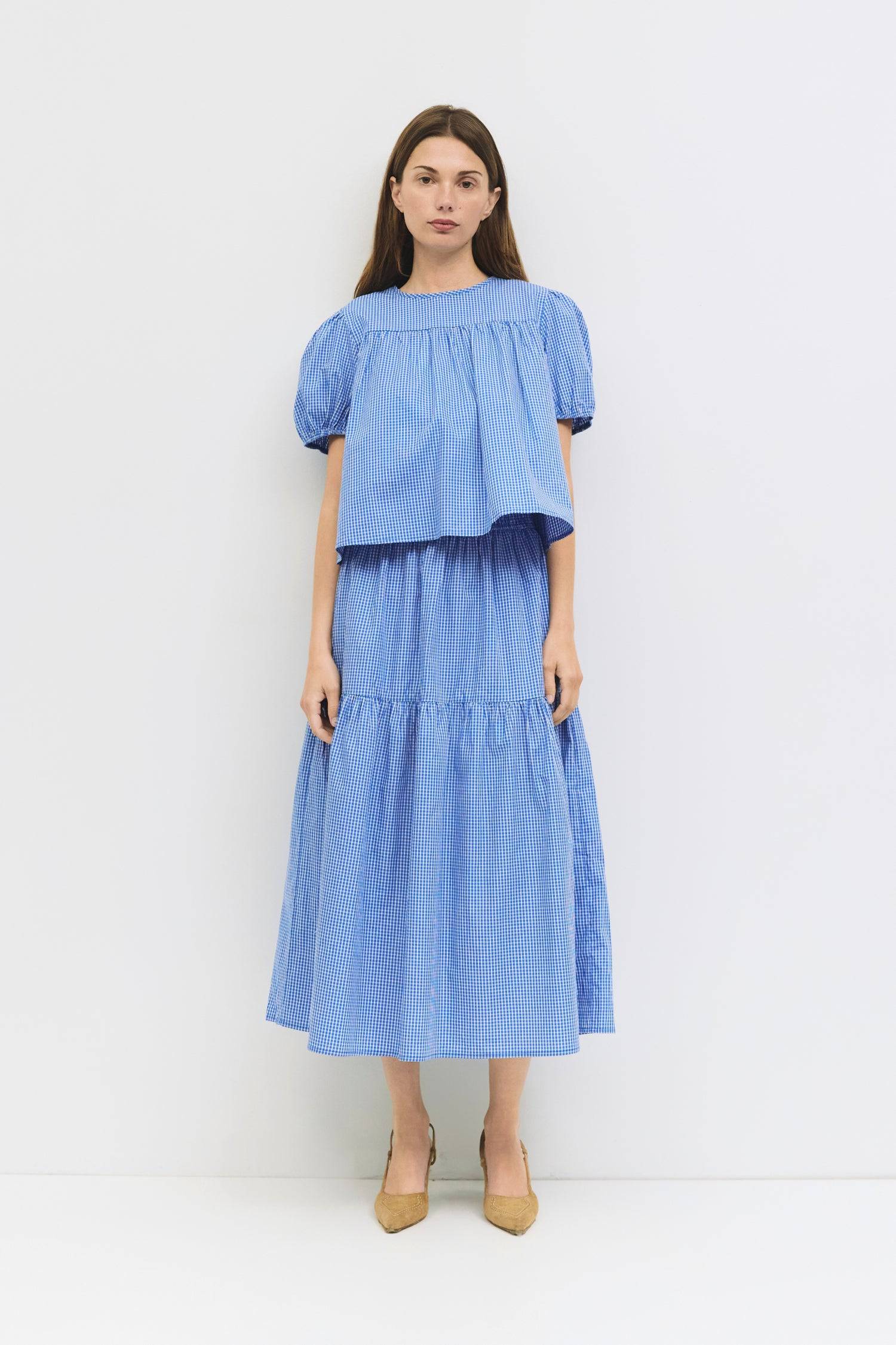 8994150711517, The Carroll Top, Tops, All Row, back tie,Black,Blue,brown,cf-color-blue,cf-color-brown,cf-color-lightblue,cf-size-l,cf-vendor-all-row,collared,Comfort,Comfortable,Cropped,cropped hemline,Feminine,gingham,Light Blue,new,plaid,Puff Sleeve,semi-cropped,Spring,versatile,Womens, Information The Carroll Top is a lightweight gingham blouse with short puff sleeves and an elastic hem for a relaxed, feminine fit. Featuring a center back tie closure and sheer front and back yokes, it’s an easy-to-wear p