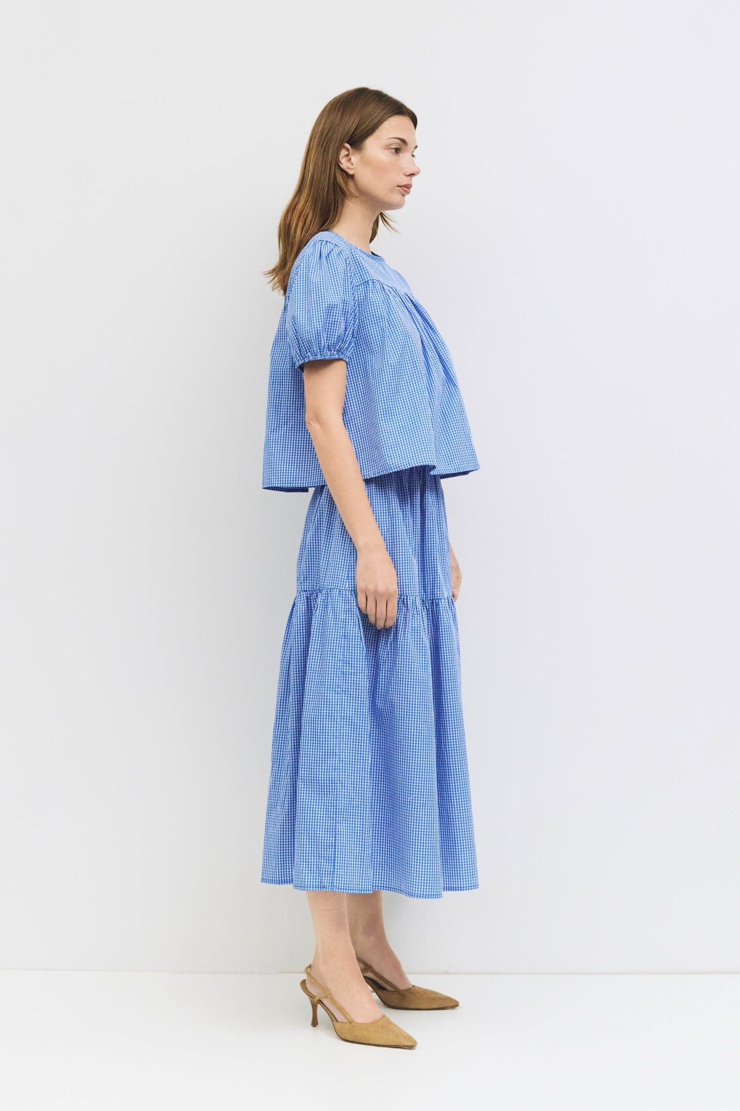 8994150711517, The Carroll Top, Tops, All Row, back tie,Black,Blue,brown,cf-color-blue,cf-color-brown,cf-color-lightblue,cf-size-l,cf-vendor-all-row,collared,Comfort,Comfortable,Cropped,cropped hemline,Feminine,gingham,Light Blue,new,plaid,Puff Sleeve,semi-cropped,Spring,versatile,Womens, Information The Carroll Top is a lightweight gingham blouse with short puff sleeves and an elastic hem for a relaxed, feminine fit. Featuring a center back tie closure and sheer front and back yokes, it’s an easy-to-wear p