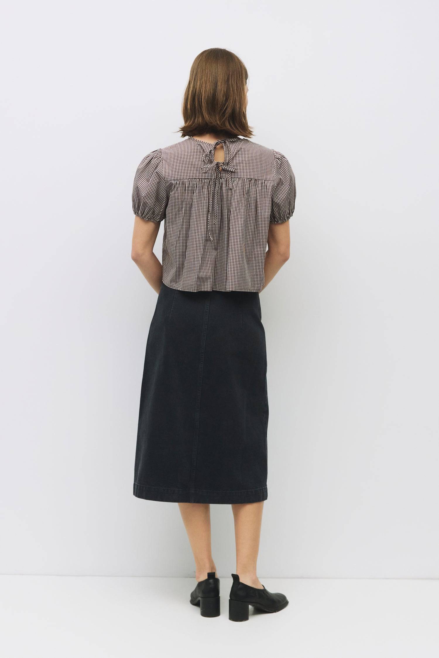 8994150711517, The Carroll Top, Tops, All Row, back tie,Black,Blue,brown,cf-color-blue,cf-color-brown,cf-color-lightblue,cf-size-l,cf-vendor-all-row,collared,Comfort,Comfortable,Cropped,cropped hemline,Feminine,gingham,Light Blue,new,plaid,Puff Sleeve,semi-cropped,Spring,versatile,Womens, Information The Carroll Top is a lightweight gingham blouse with short puff sleeves and an elastic hem for a relaxed, feminine fit. Featuring a center back tie closure and sheer front and back yokes, it’s an easy-to-wear p