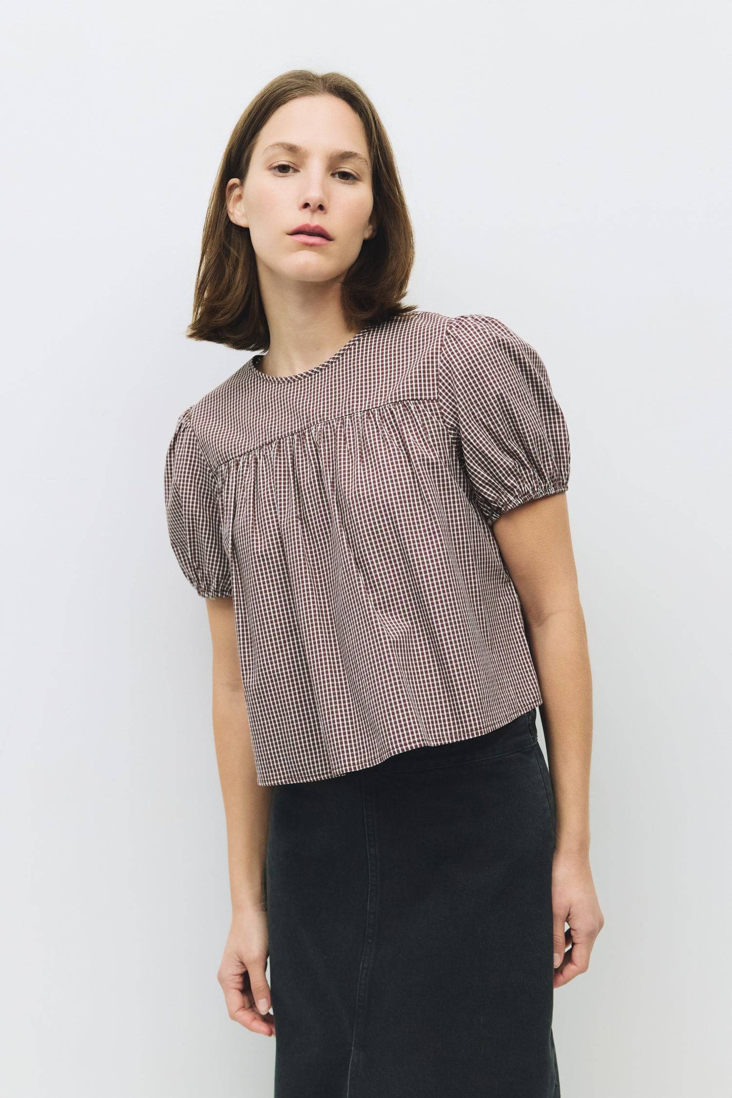 8994150711517, The Carroll Top, Tops, All Row, back tie,Black,Blue,brown,cf-color-blue,cf-color-brown,cf-color-lightblue,cf-size-l,cf-vendor-all-row,collared,Comfort,Comfortable,Cropped,cropped hemline,Feminine,gingham,Light Blue,new,plaid,Puff Sleeve,semi-cropped,Spring,versatile,Womens, Information The Carroll Top is a lightweight gingham blouse with short puff sleeves and an elastic hem for a relaxed, feminine fit. Featuring a center back tie closure and sheer front and back yokes, it’s an easy-to-wear p