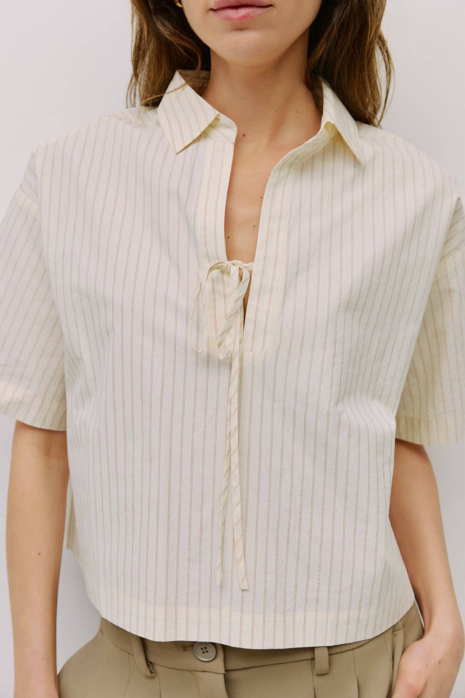 8994112209117, The Madden Top, Tops, All Row, All Row,allrow,beige,Black,Casual,cf-color-beige,cf-color-black,cf-color-white,cf-size-l,cf-size-m,cf-size-s,cf-vendor-all-row,Comfortable,Cozy,flattering,knit,new,off shoulder,set,Sets,Short Sleeve,Spring,Summer,Twist,Women's,womens top, Information The Madden Top is a pinstripe collared shirt with a relaxed, boxy fit, mid-length sleeves, tie front, and side slits for an easy, modern silhouette. Details 100% Cotton Boxy Fit Tie Front Side Slit Detail Collared V