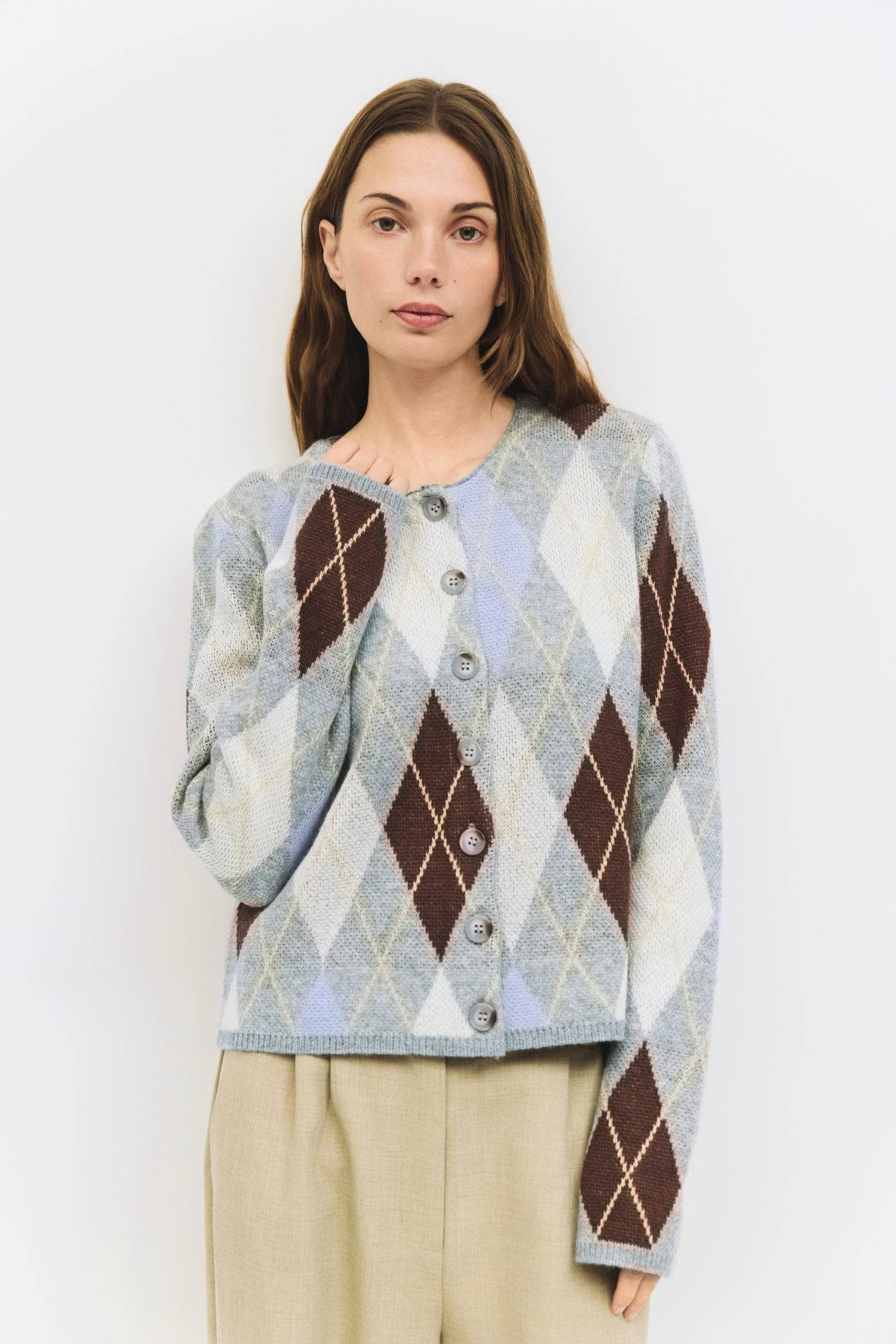 9084469608669, The Gayle Cardigan, Outerwear, Mod Ref, Acrylic,Cardigan,Casual,cf-color-grey,cf-color-sage,cf-size-l,cf-size-m,cf-size-s,cf-size-xl,cf-size-xs,cf-vendor-mod-ref,crewneck,Everyday,fall,Grey,Heather Grey,Long Sleeve,Mod Ref,modref,new,Pullover,Relaxed,Relaxed Fit,Sweater,Transitional,Women's,Wool,wool blend, Information The Gayle Cardigan is a relaxed-fit knit featuring a classic argyle design. It has a crewneck, long sleeves, and a front button closure. Made from midweight knit, it’s a timele