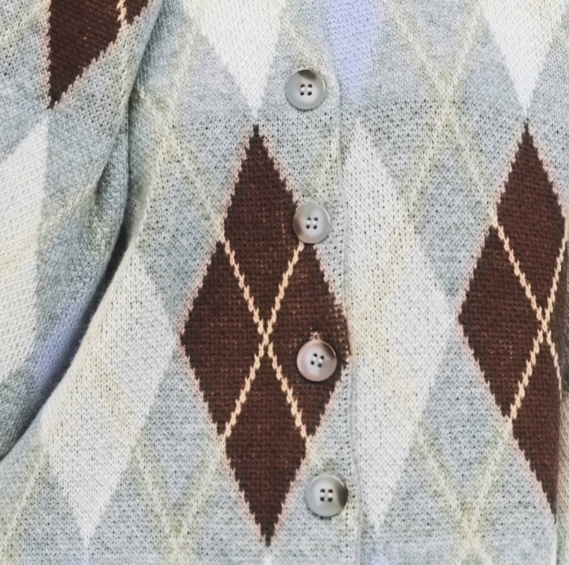 9084469608669, The Gayle Cardigan, Outerwear, Mod Ref, Acrylic,Cardigan,Casual,cf-color-grey,cf-color-sage,cf-size-l,cf-size-m,cf-size-s,cf-size-xl,cf-size-xs,cf-vendor-mod-ref,crewneck,Everyday,fall,Grey,Heather Grey,Long Sleeve,Mod Ref,modref,new,Pullover,Relaxed,Relaxed Fit,Sweater,Transitional,Women's,Wool,wool blend, Information The Gayle Cardigan is a relaxed-fit knit featuring a classic argyle design. It has a crewneck, long sleeves, and a front button closure. Made from midweight knit, it’s a timele